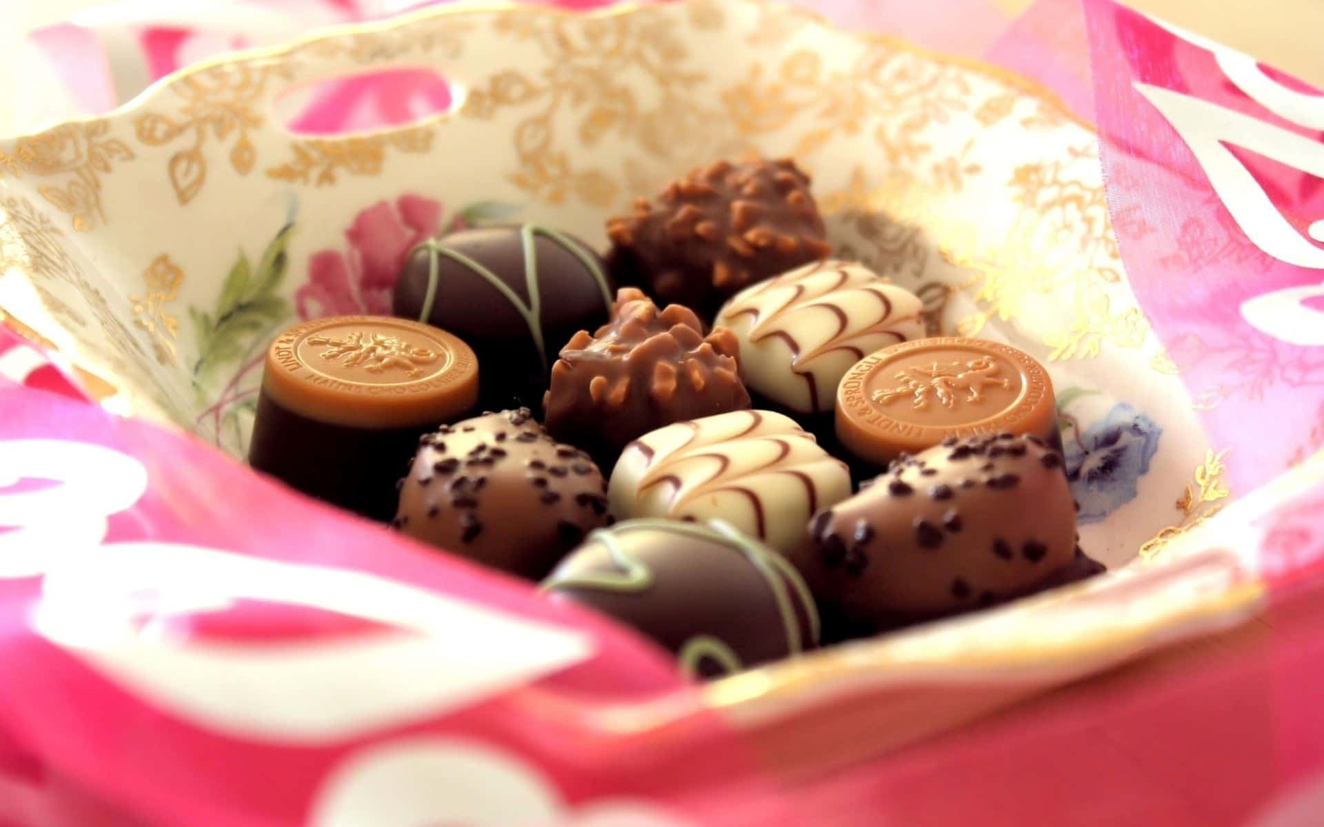 gourmet chocolates, floral-patterned bowl, pink wrapping paper, Full HD Desktop Wallpaper