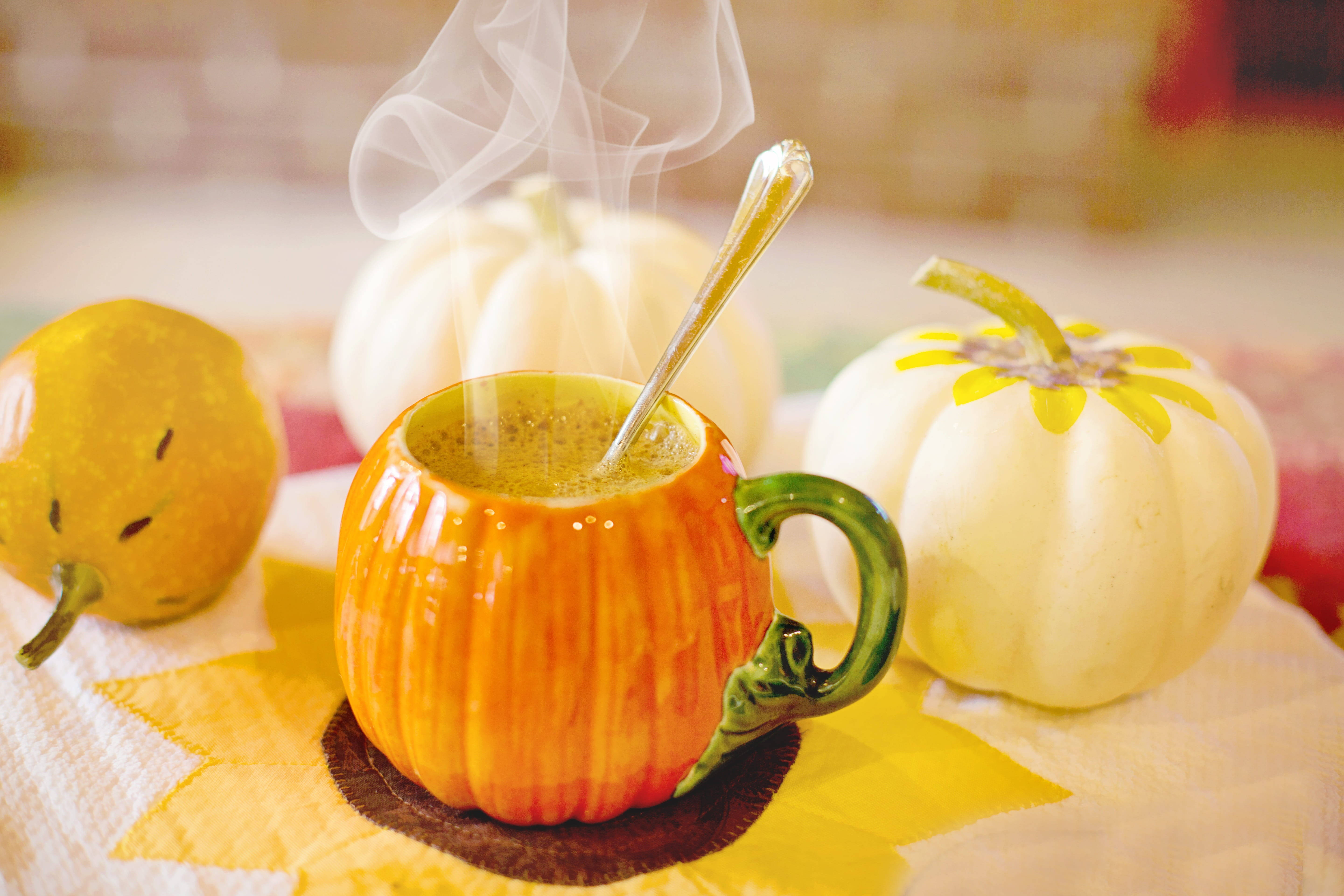 pumpkin spice latte, steaming orange pumpkin mug, sunflower-patterned cloth, 5K Desktop Wallpaper