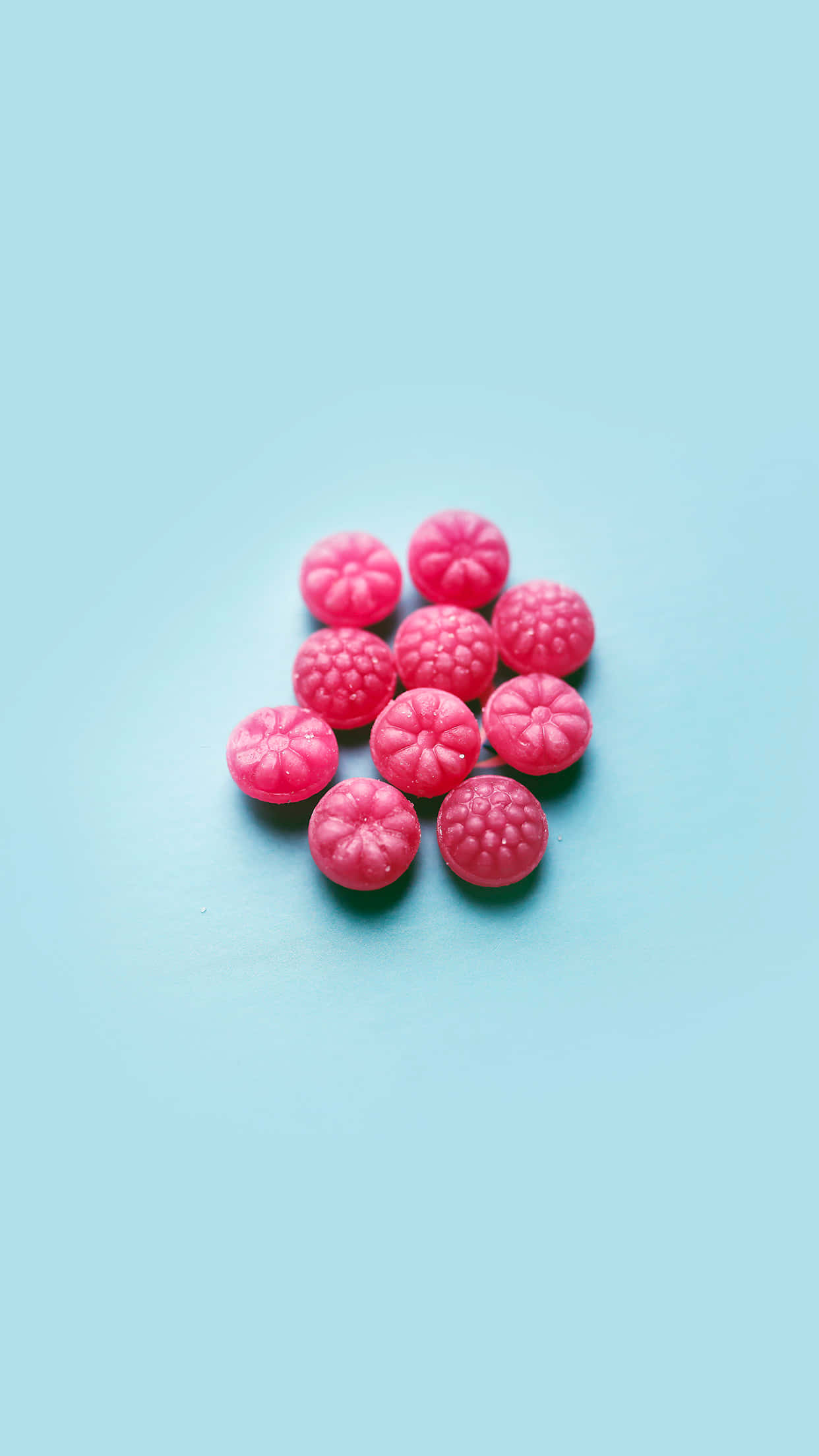 cute food iphone, bright pink raspberry-shaped candies, soft pastel blue surface, Full HD Phone Wallpaper