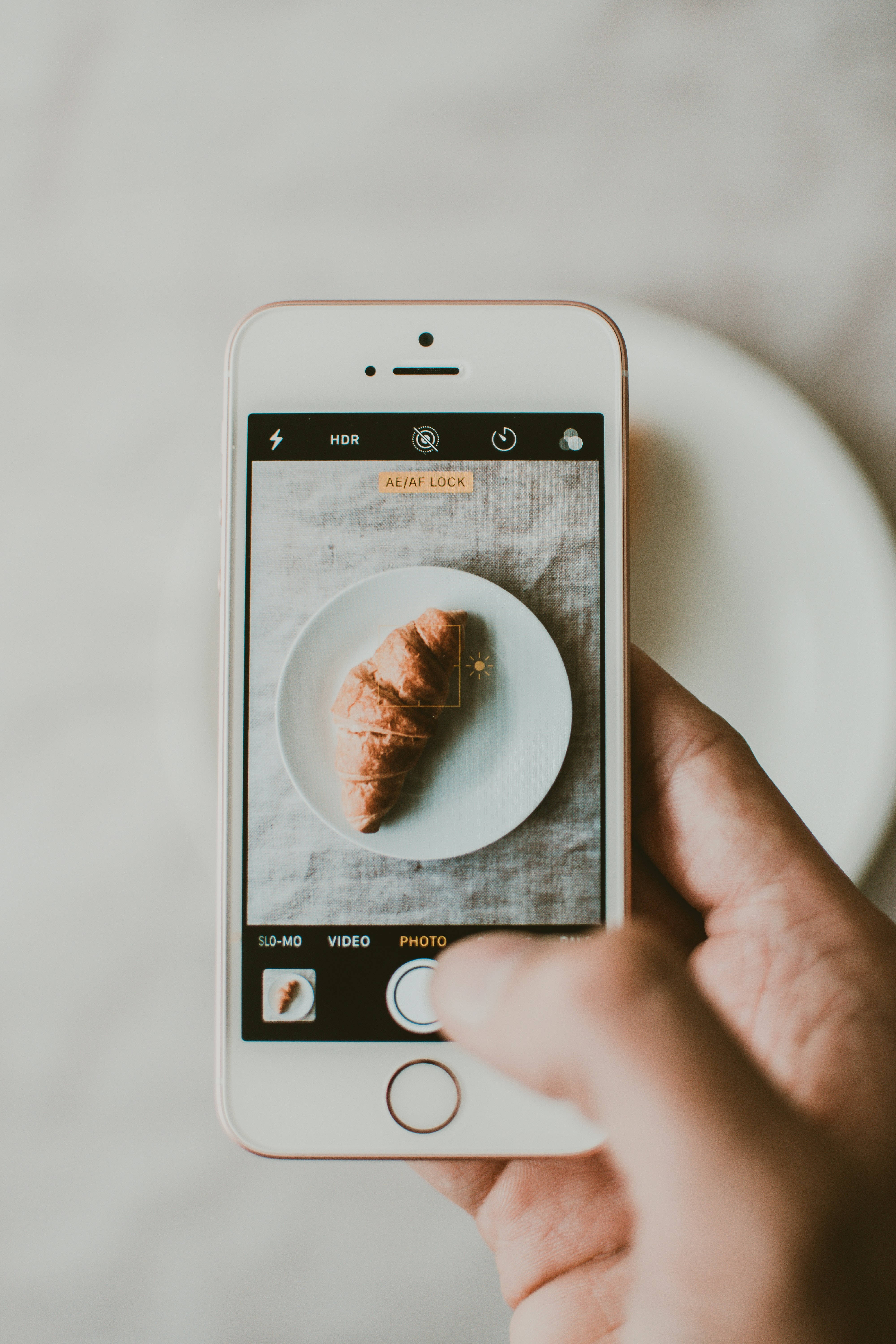 iPhone, croissant, white plate, 5K Phone Wallpaper