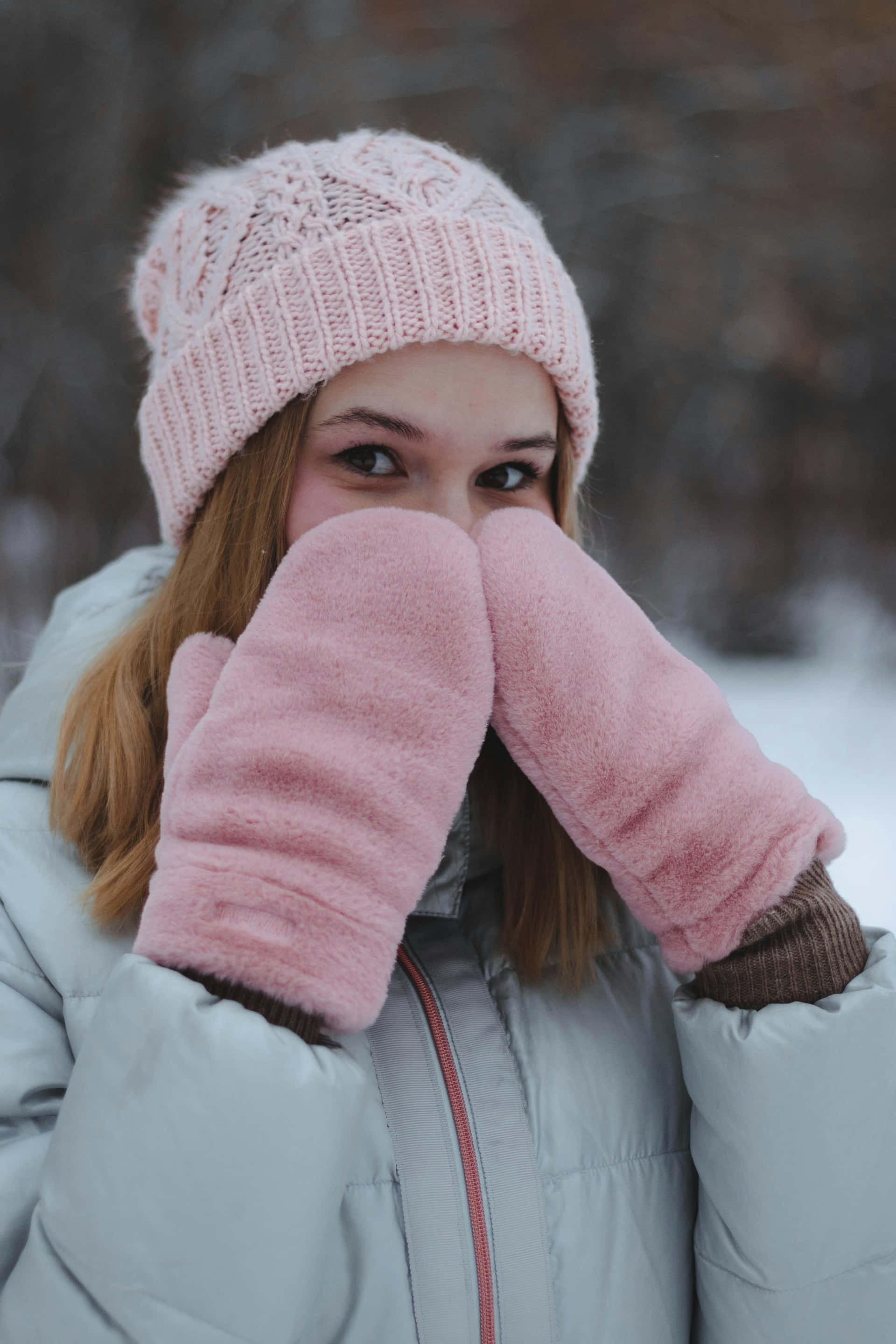 light pink knit hat, matching fluffy mittens, snowy outdoor setting, 2K Phone Wallpaper