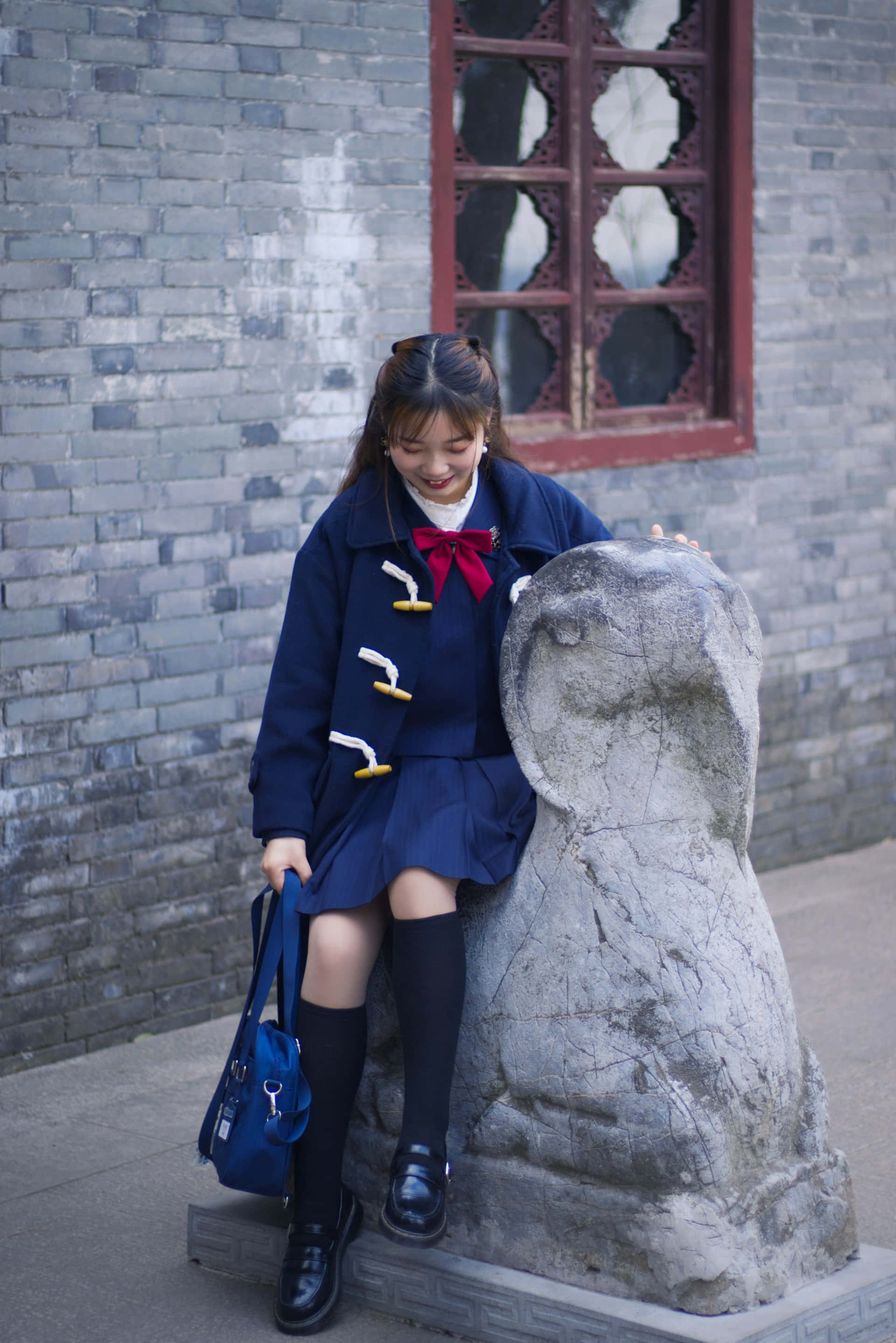 navy blue school uniform, red bow, weathered stone statue, 2K Phone Wallpaper
