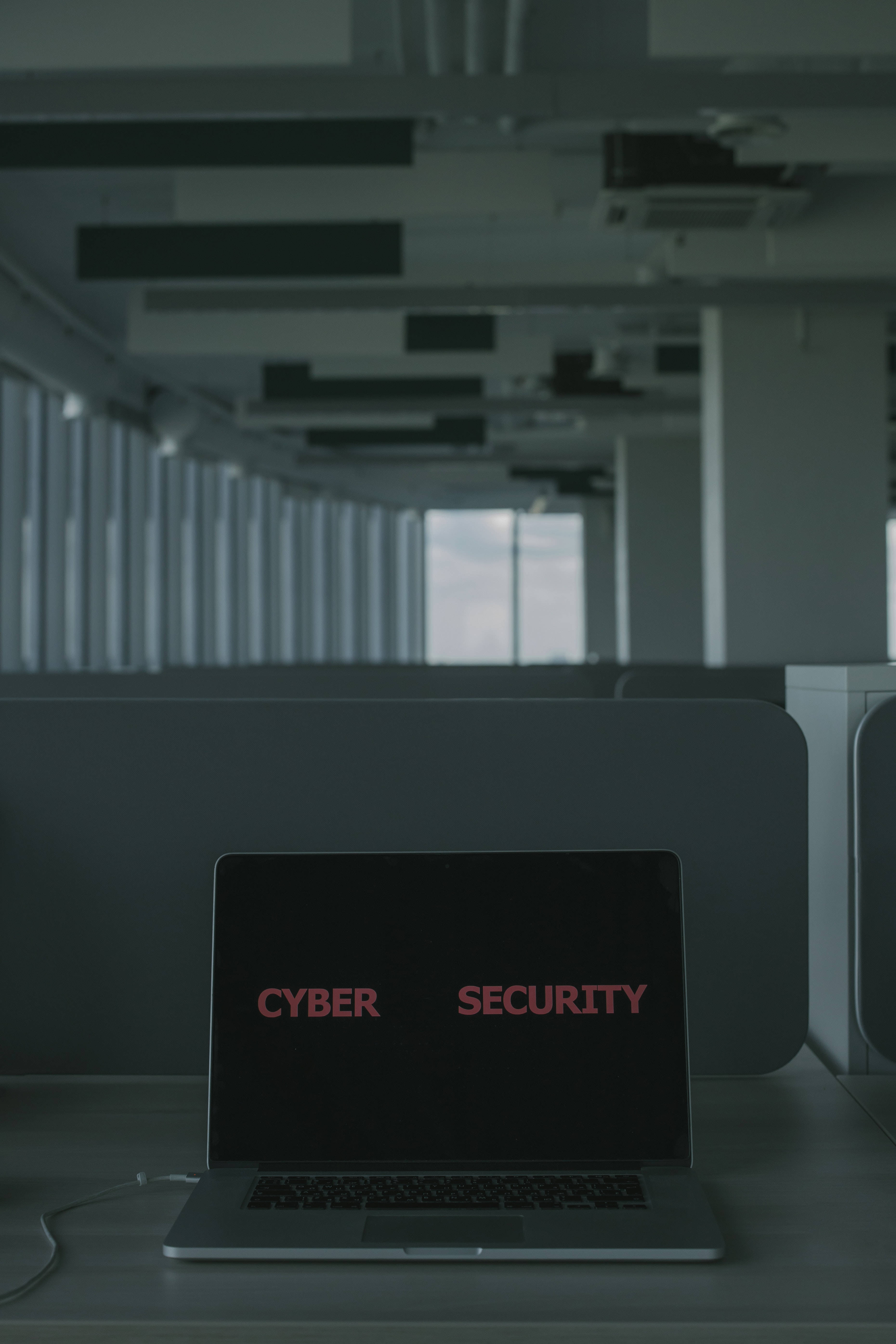 pink laptop, red cyber security text, dimly lit modern office, 5K Phone Wallpaper