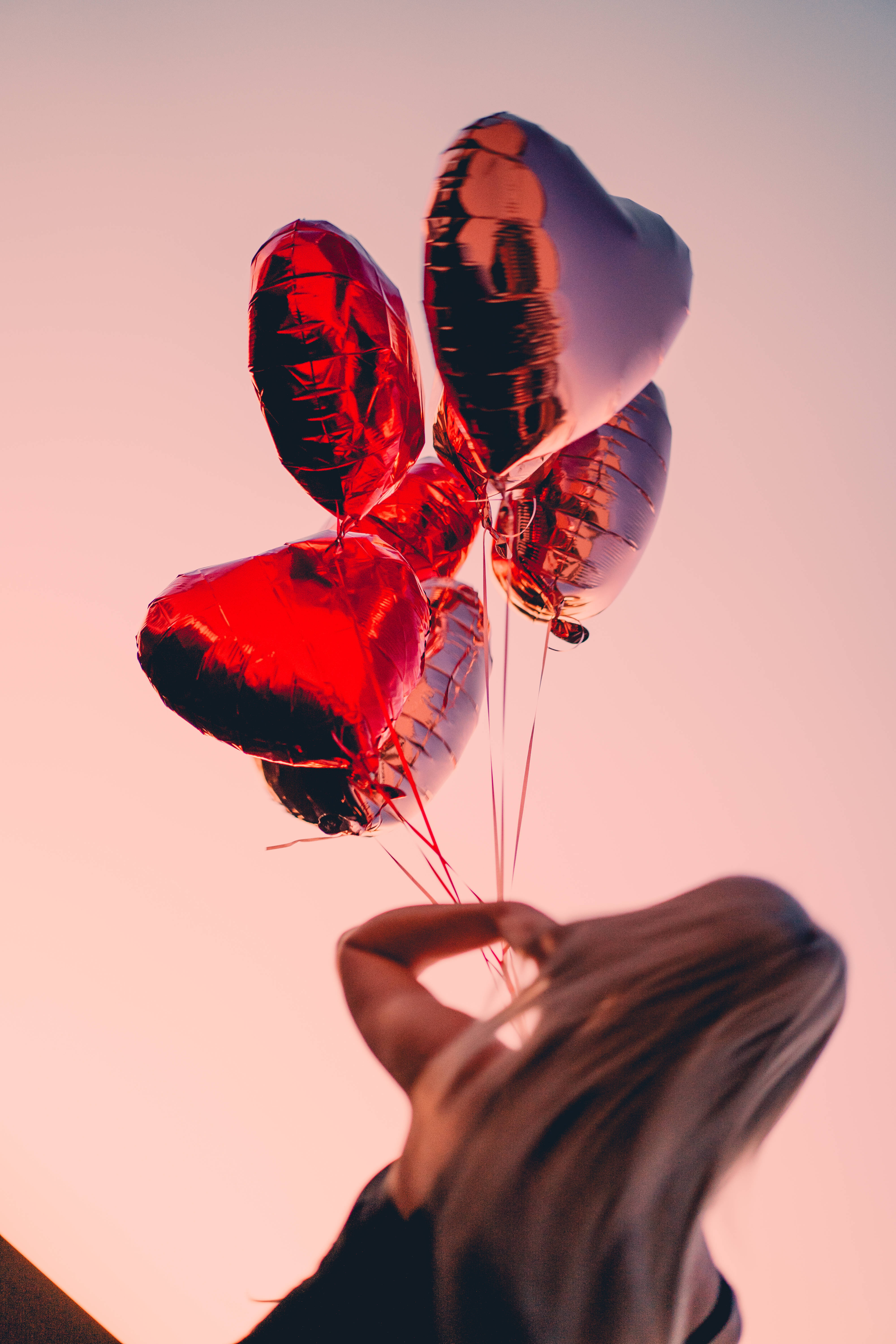 red balloons, shiny red and silver heart-shaped balloons, soft pink sunset sky, 5K Phone Wallpaper