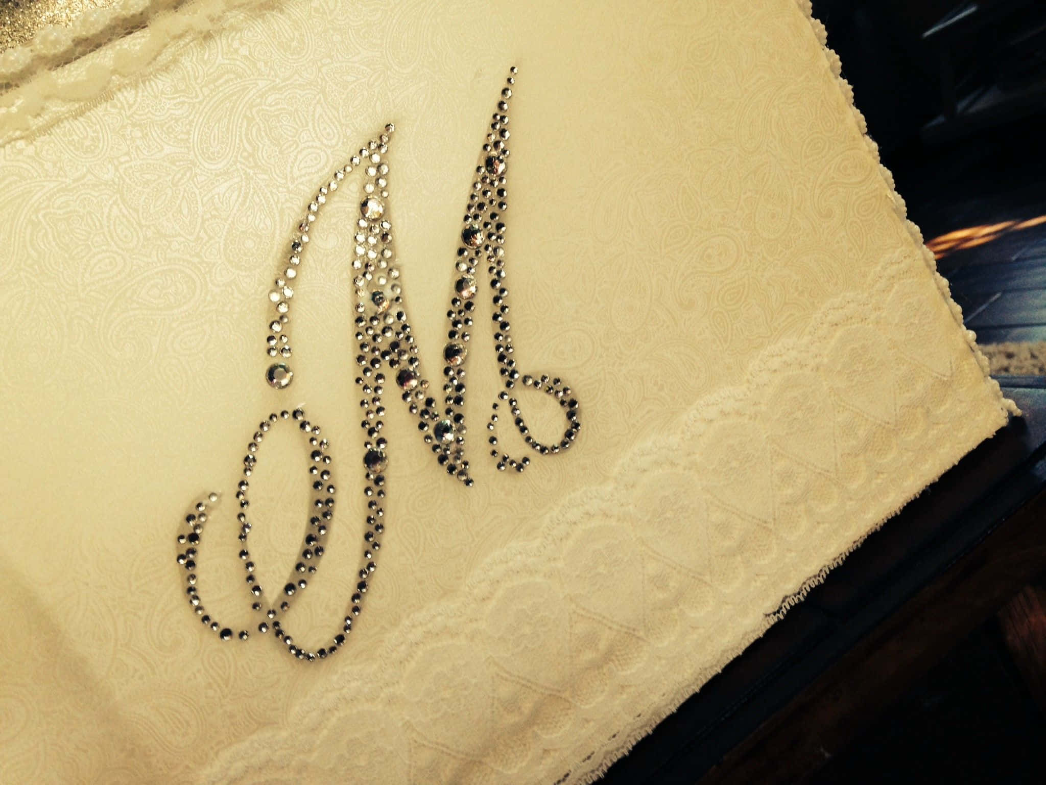 cream-colored fabric, sparkling rhinestone monogram 'M', lace trim, Full HD Desktop Wallpaper