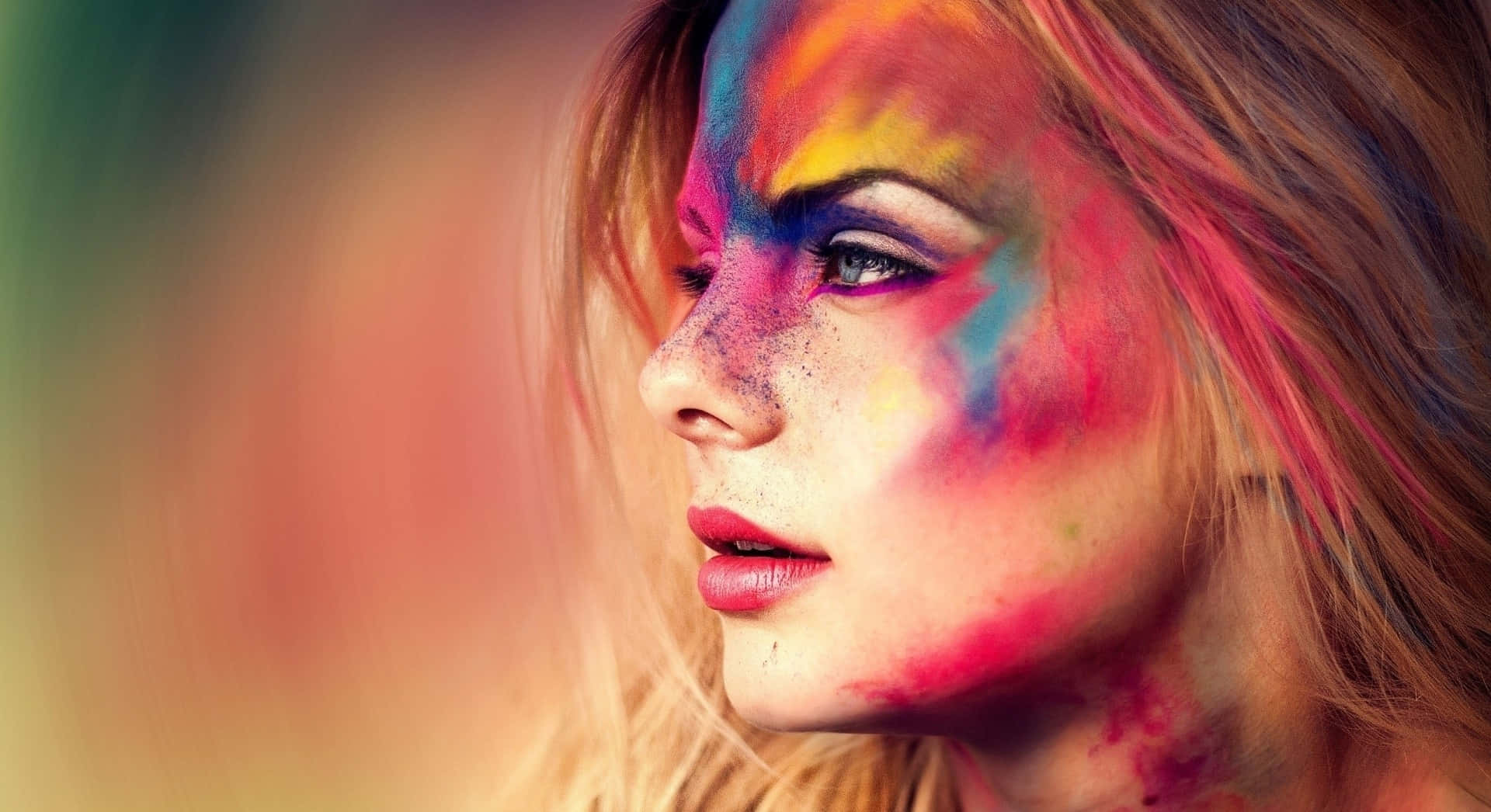 colorful face paint, vibrant rainbow powder, blurred warm background, Full HD Desktop Wallpaper