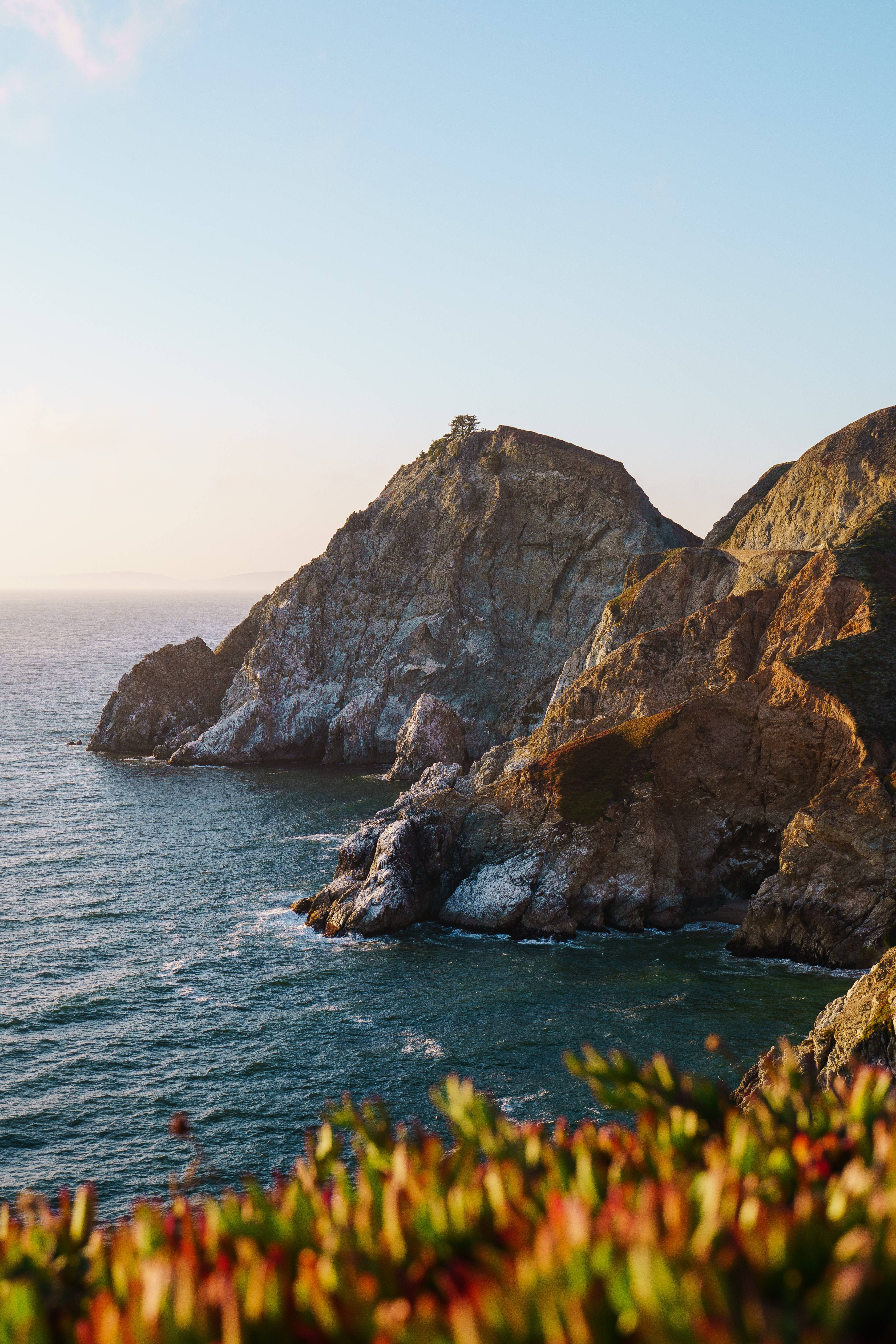 ocean rocks, sunlit coastal cliffs, rugged rock formations, 5K Phone Wallpaper