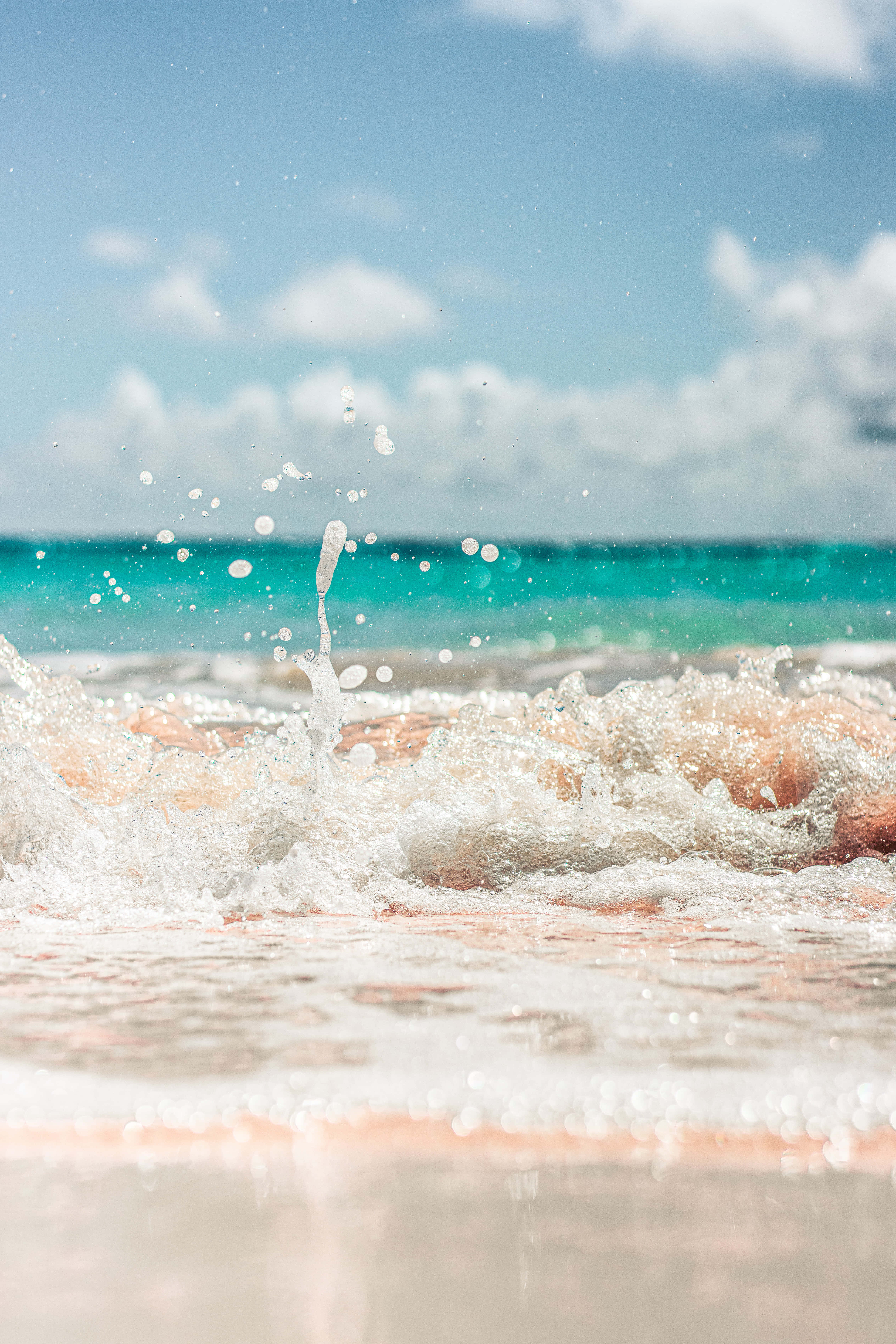 serene blue sea, sandy shore, bright blue sky, 5K Phone Wallpaper