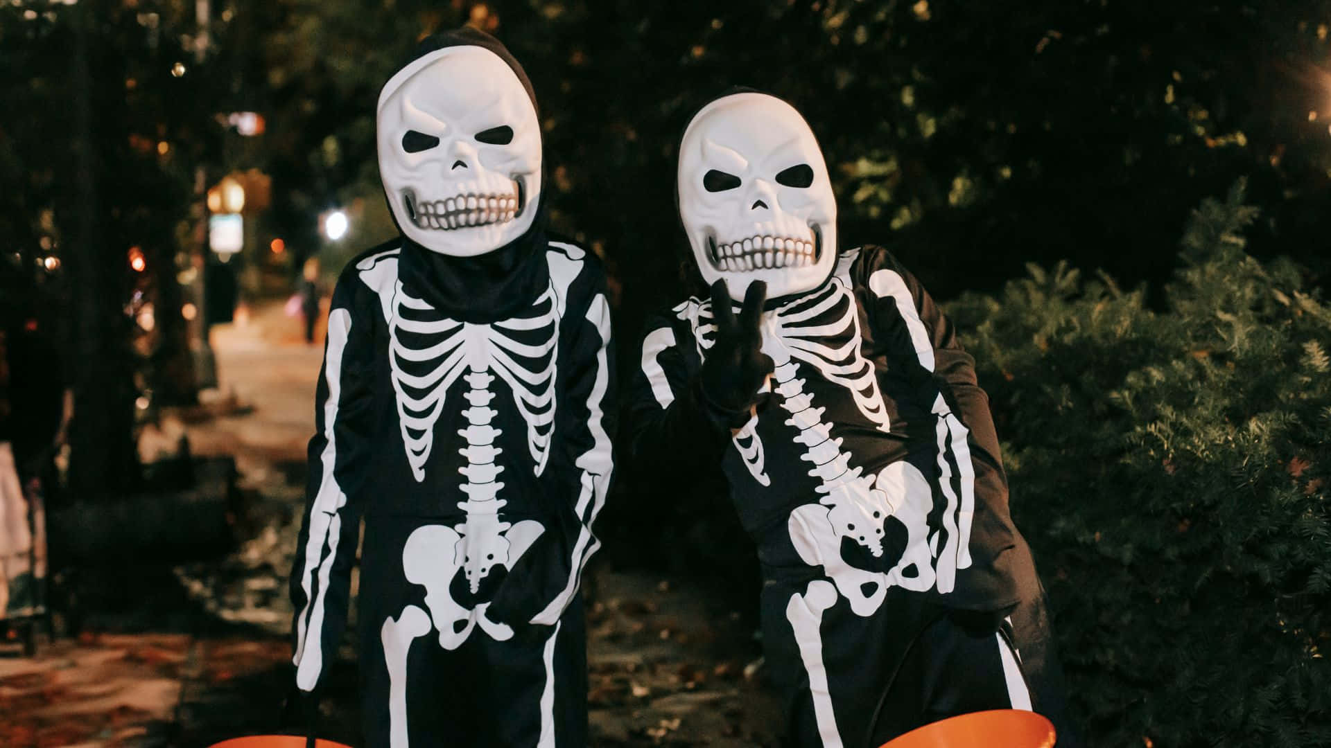 skeleton costumes, jack-o-lantern buckets, dimly lit autumn night street, Full HD Desktop Wallpaper