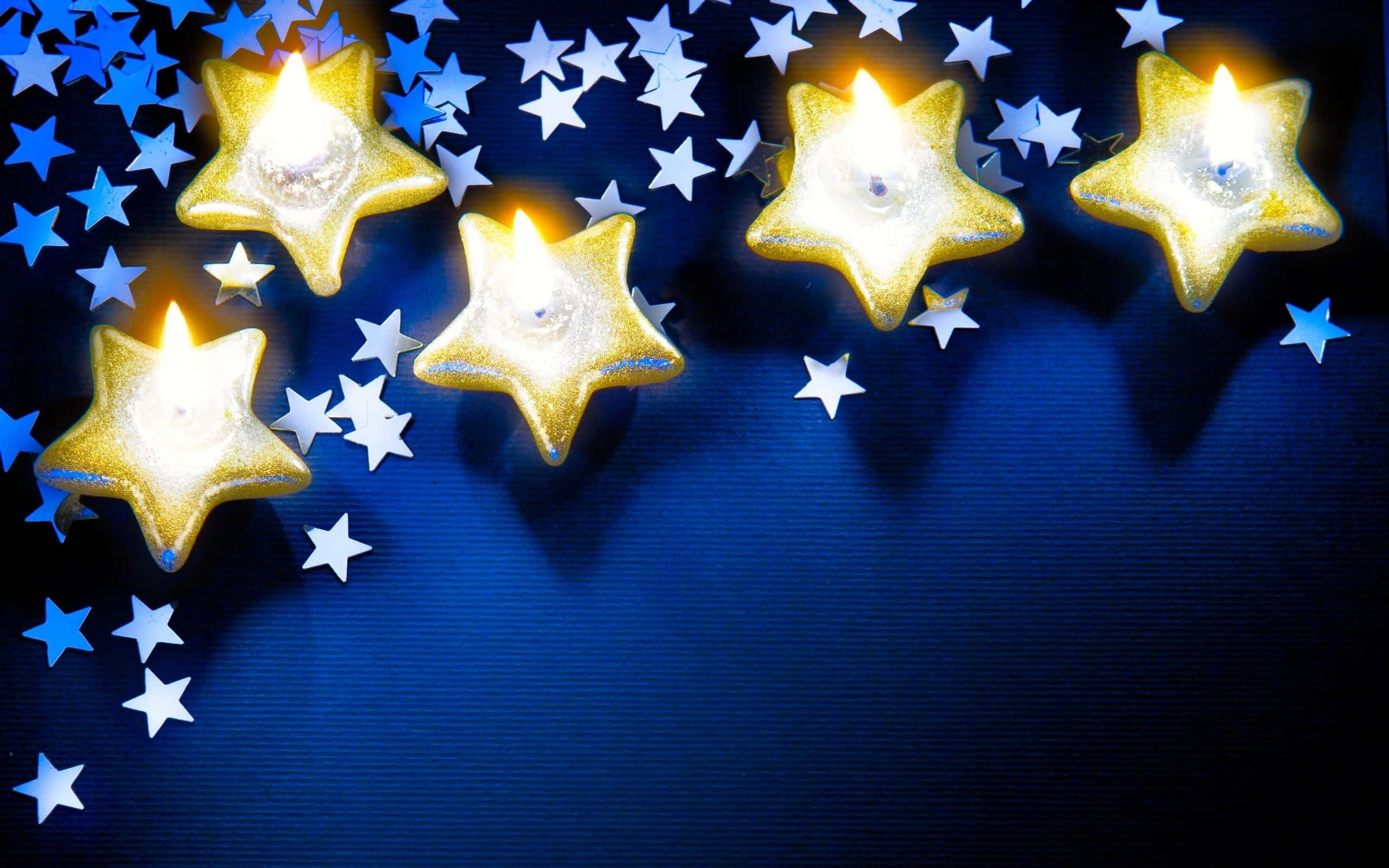 Golden star-shaped candles, deep blue background, white stars, 2K Desktop Wallpaper