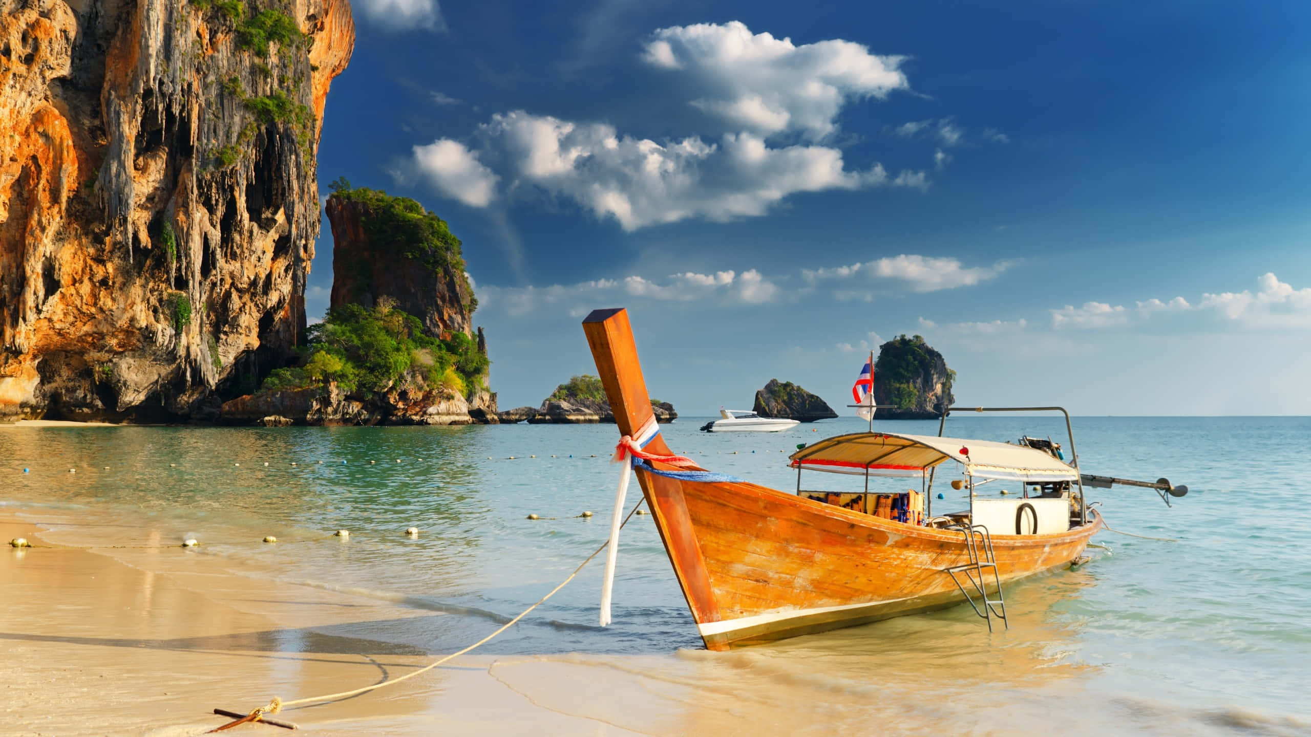 longtail boat, golden sandy beach, towering limestone cliffs, 2K Desktop Wallpaper