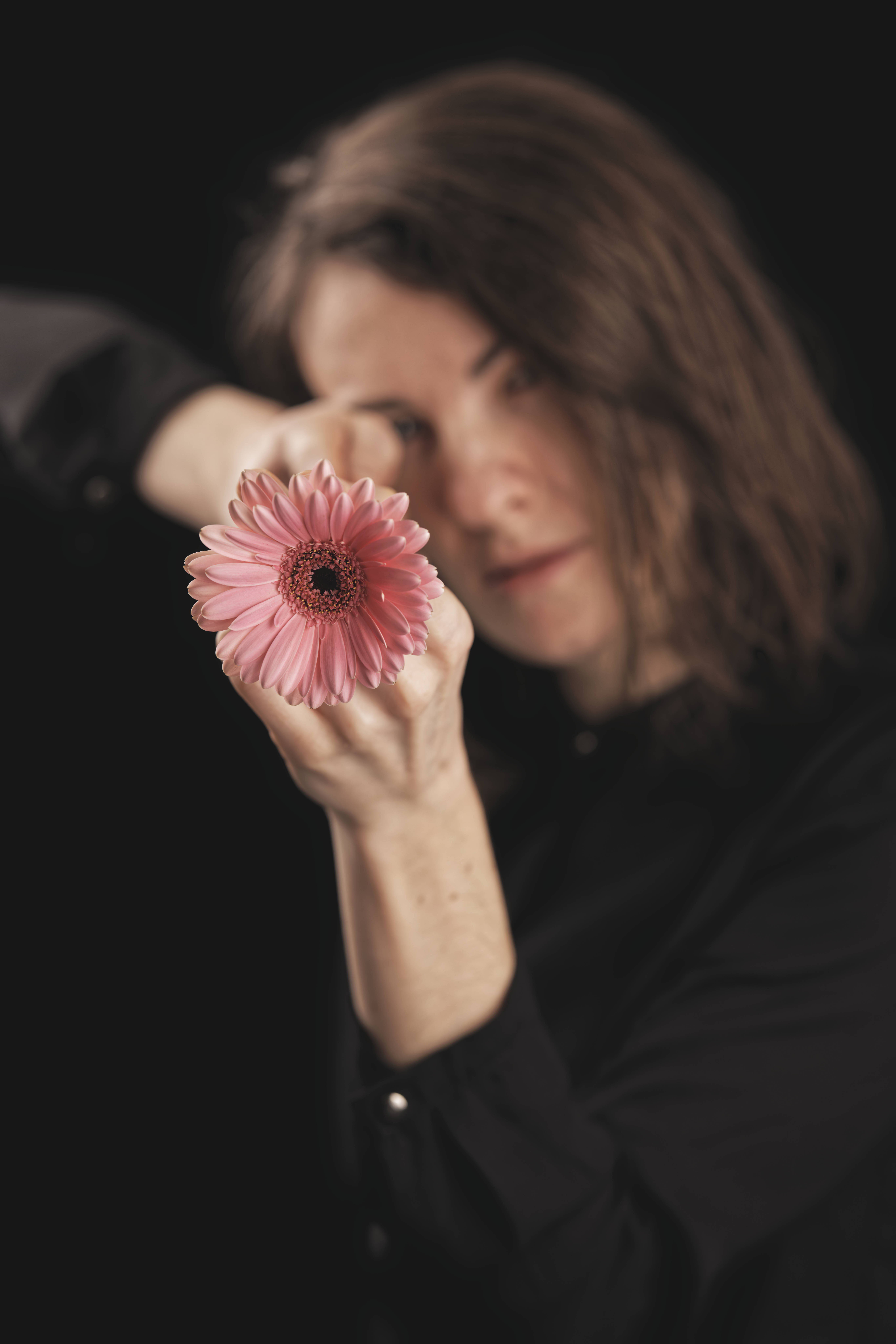 Cute Valentine's Day Flower Aim, pink gerbera daisy, woman in black, 8K Phone Wallpaper