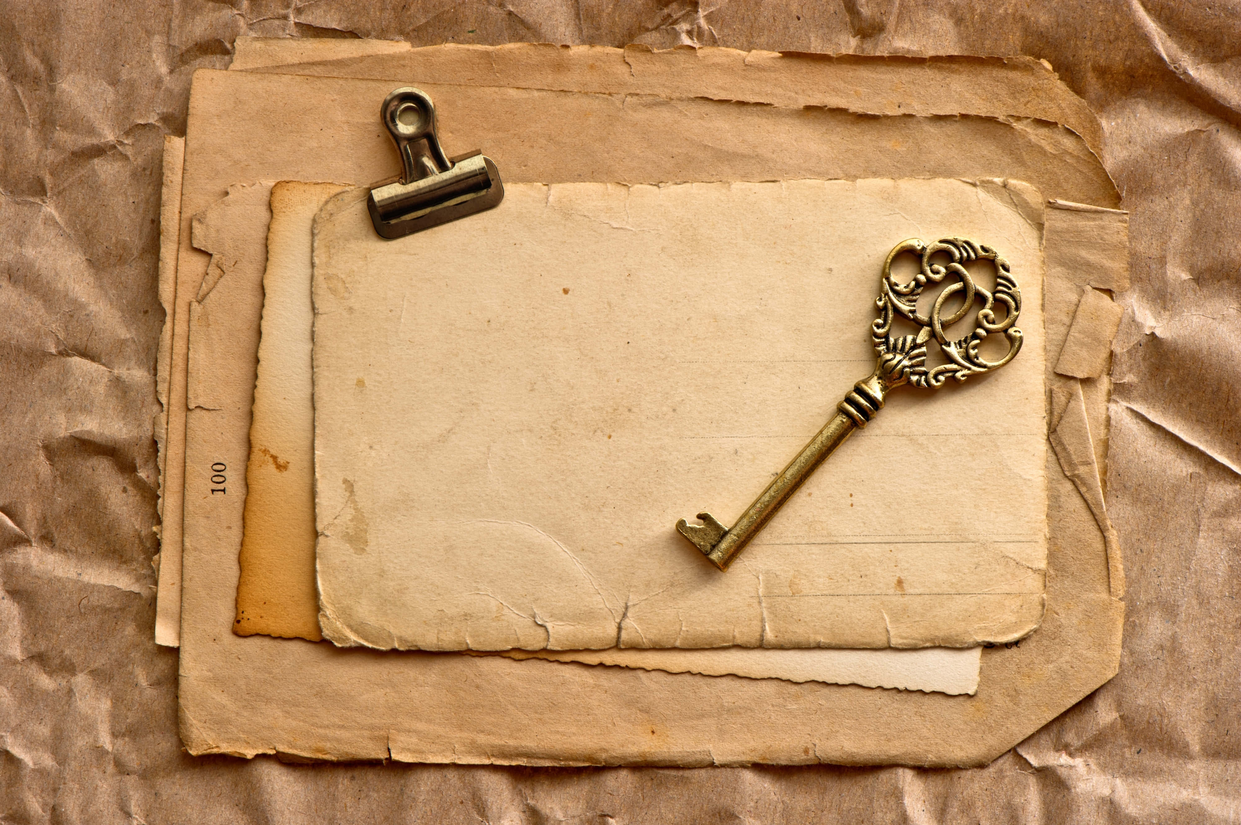 brass key, aged parchment papers, metal binder clip, 4K Desktop Wallpaper
