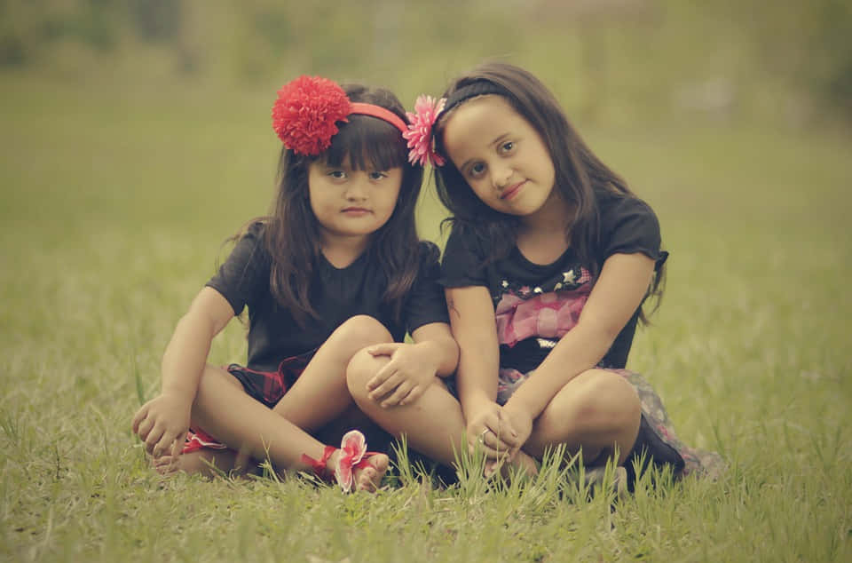 red floral headbands, grassy field, two young girls, SD Desktop Wallpaper