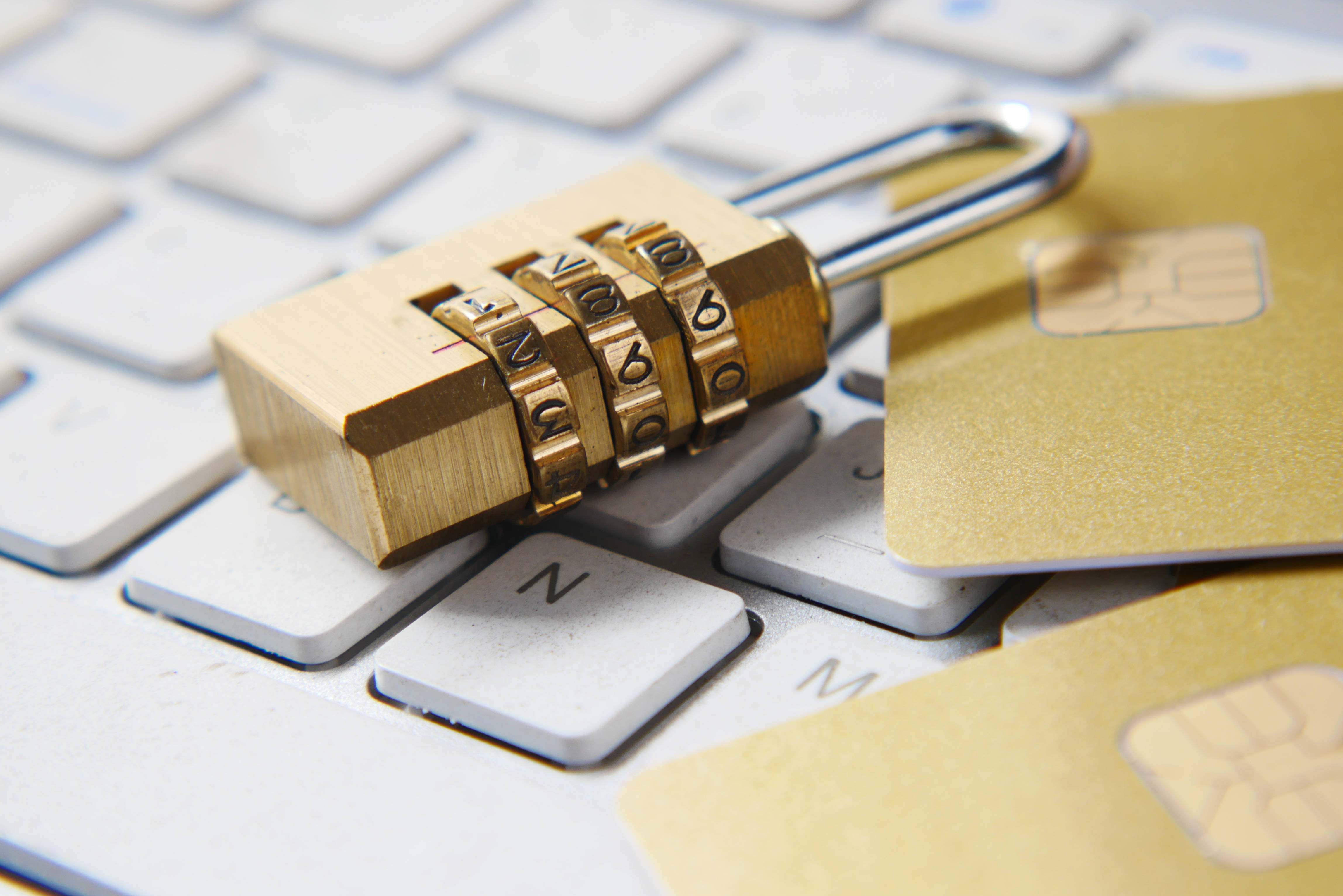 brass combination lock, gold credit cards, white computer keyboard, 4K Desktop Wallpaper