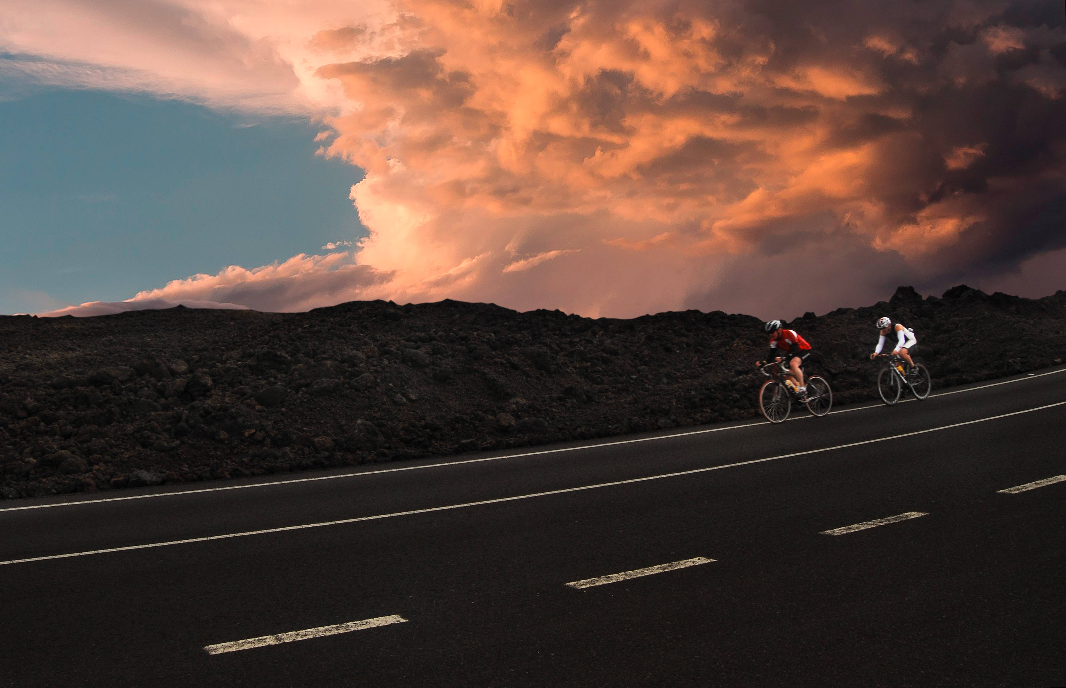 golden hour, dark volcanic road, orange and teal sunset sky, 2K Desktop Wallpaper
