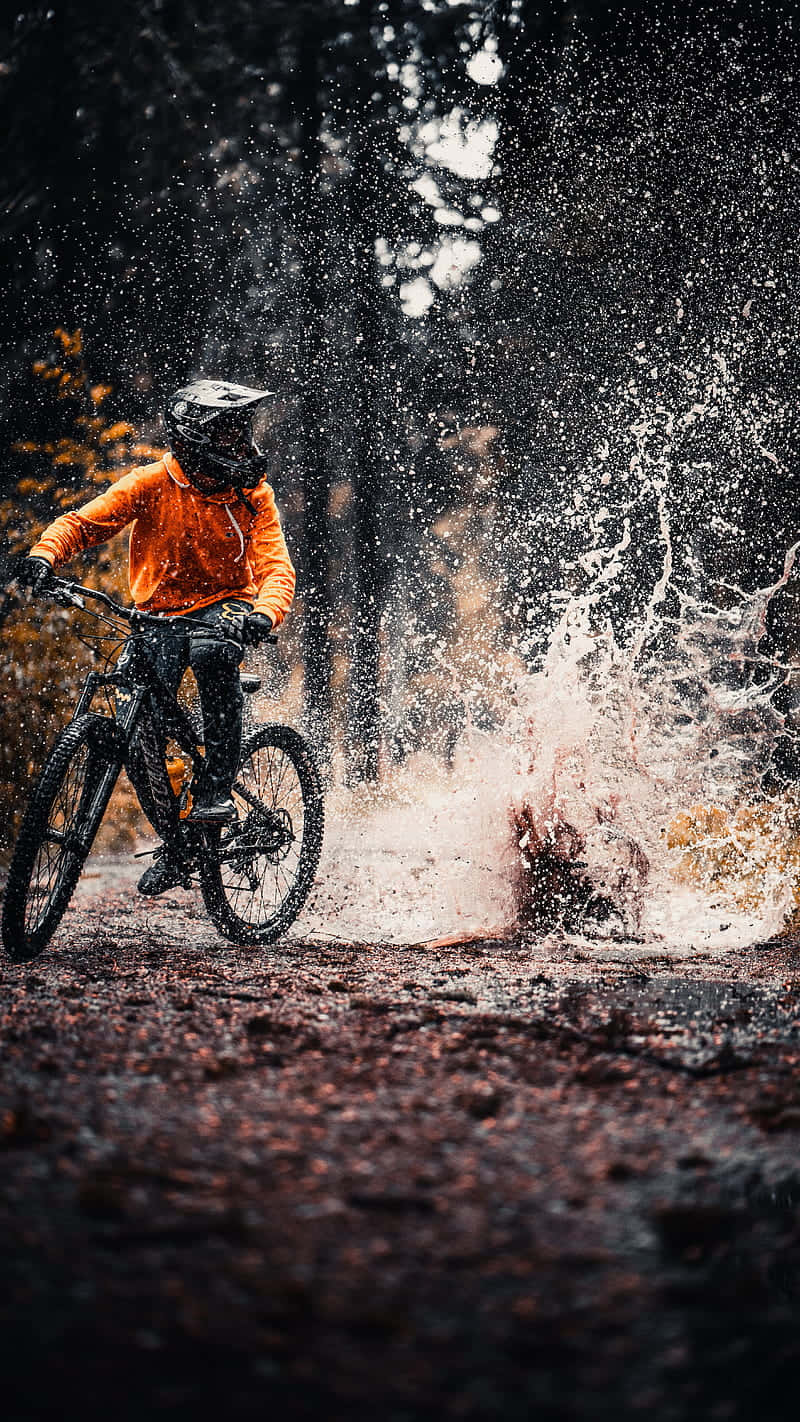 orange gear, muddy forest trail, dramatic splash of water, HD Phone Wallpaper