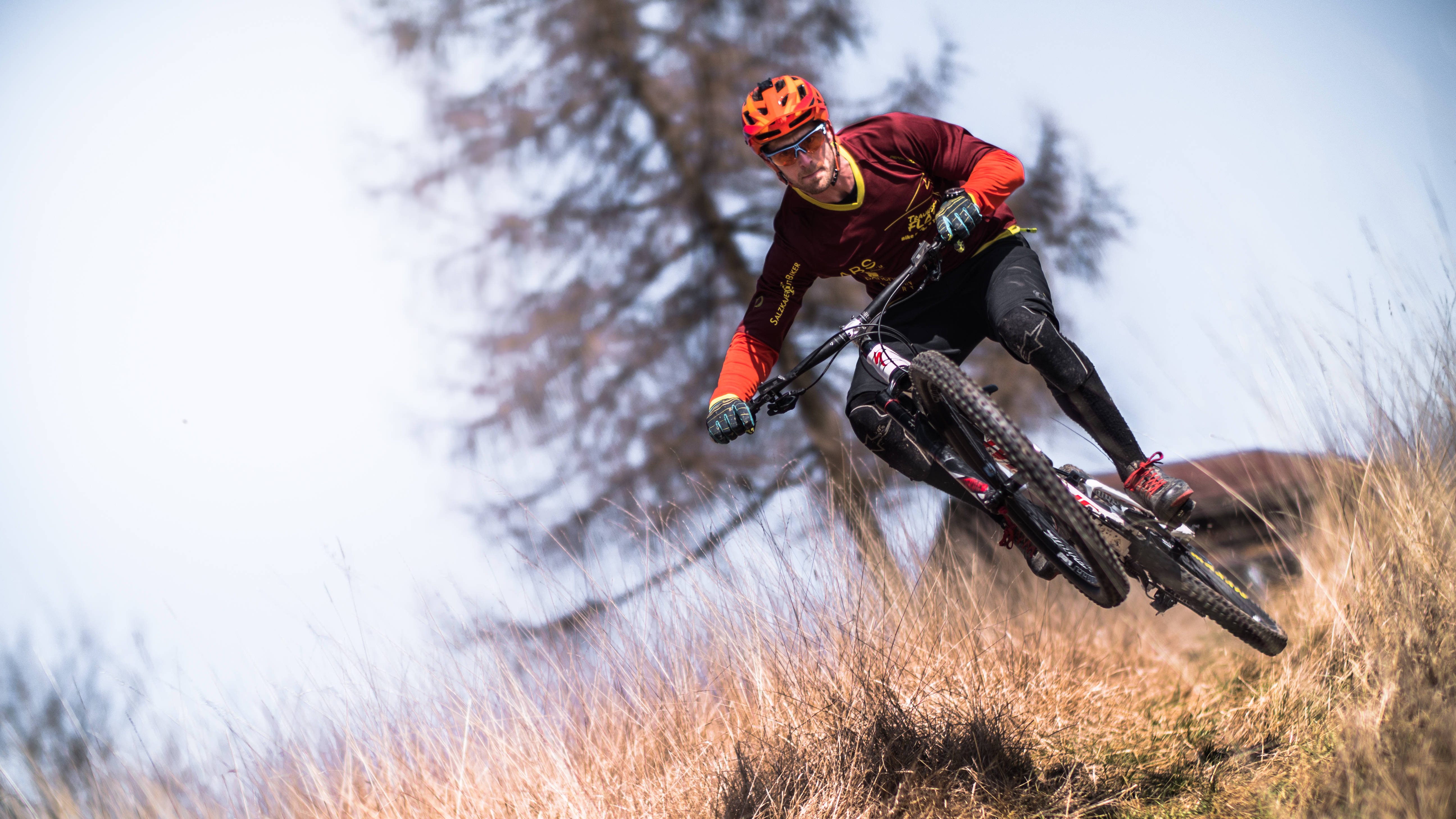 mountain biker, red gear, dry grass, 5K Desktop Wallpaper
