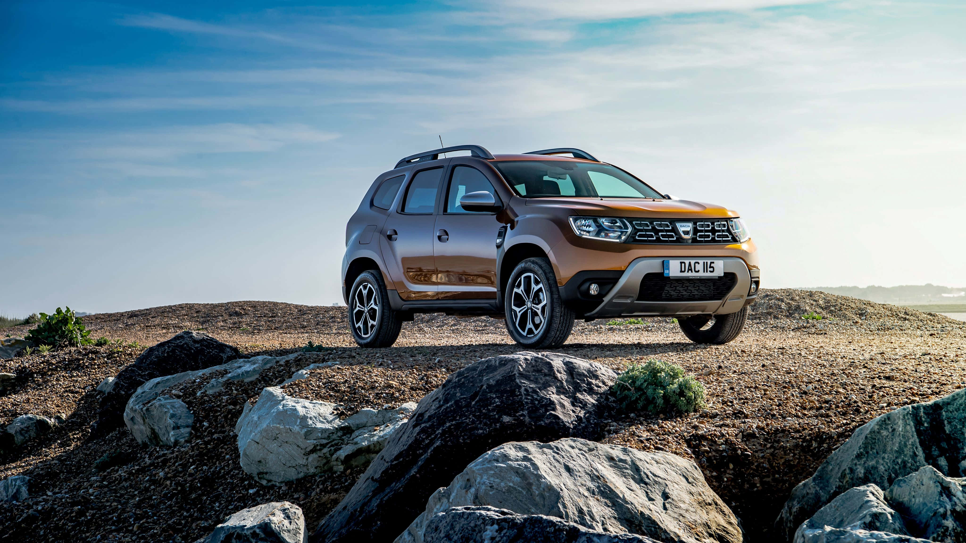 Dacia Duster, bronze, rugged rocky terrain, 4K Desktop Wallpaper