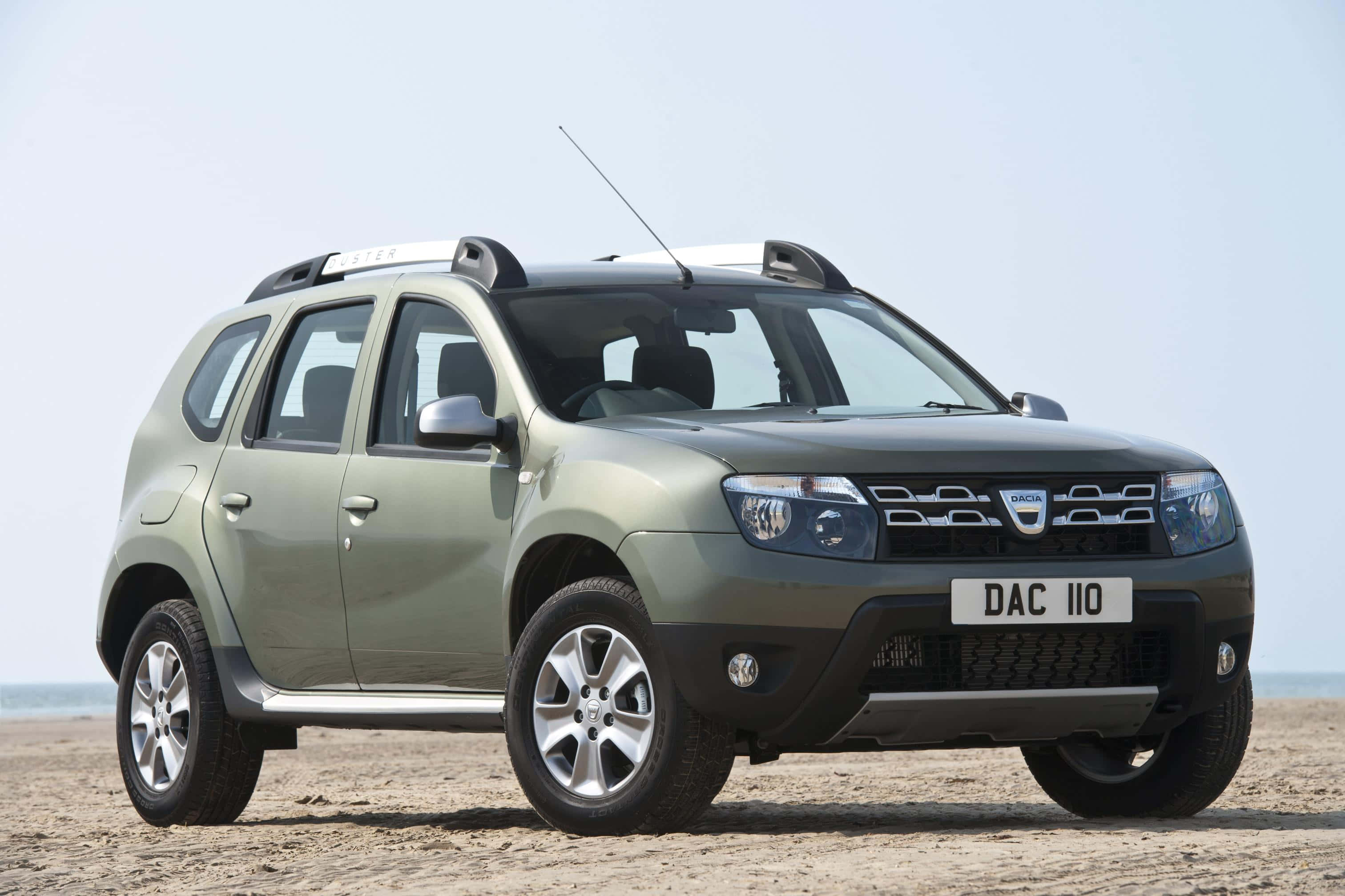 Dacia Duster, matte olive green, sandy beach, 2K Desktop Wallpaper