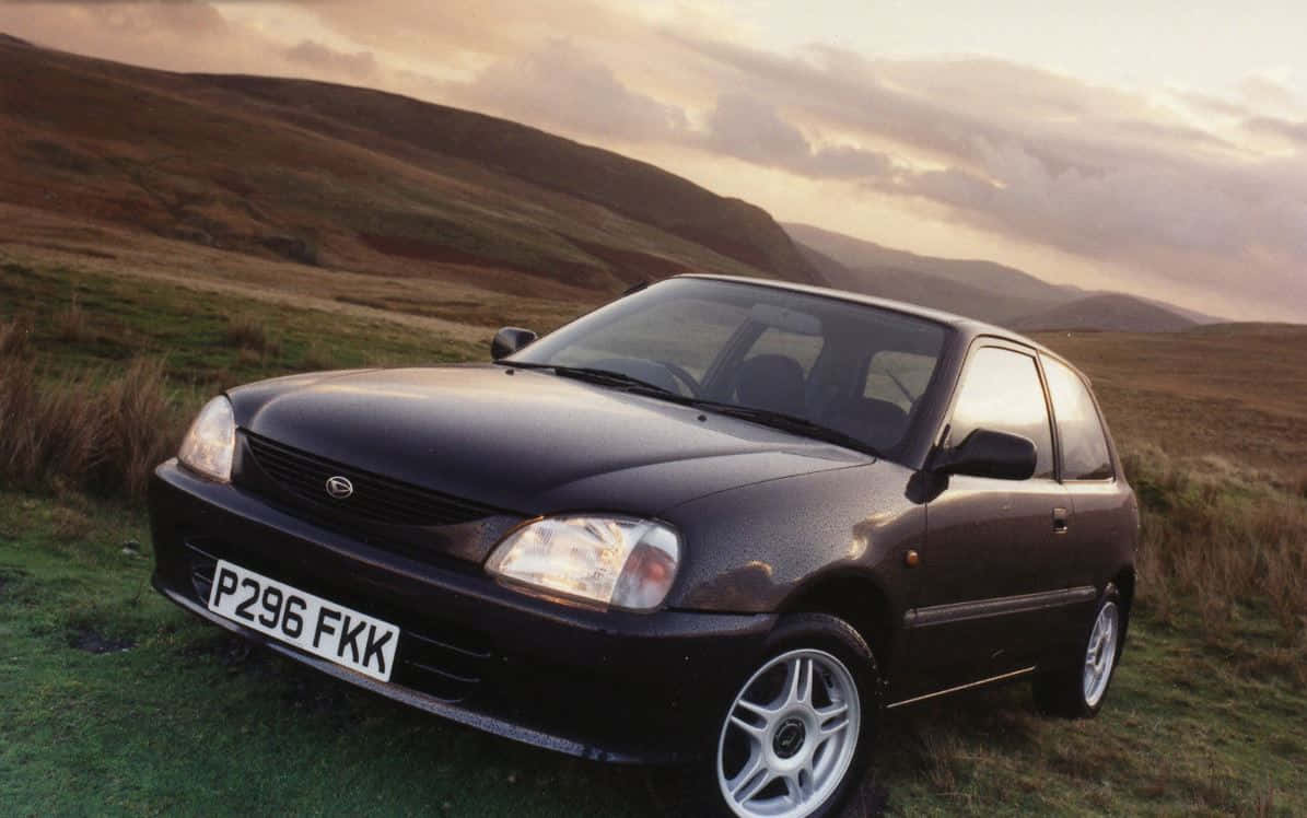 Daihatsu Charade, black hatchback, golden sunset sky, SD Desktop Wallpaper