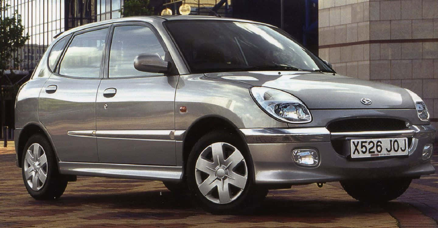 Daihatsu Sirion, sleek silver compact car, tiled pavement, HD Desktop Wallpaper