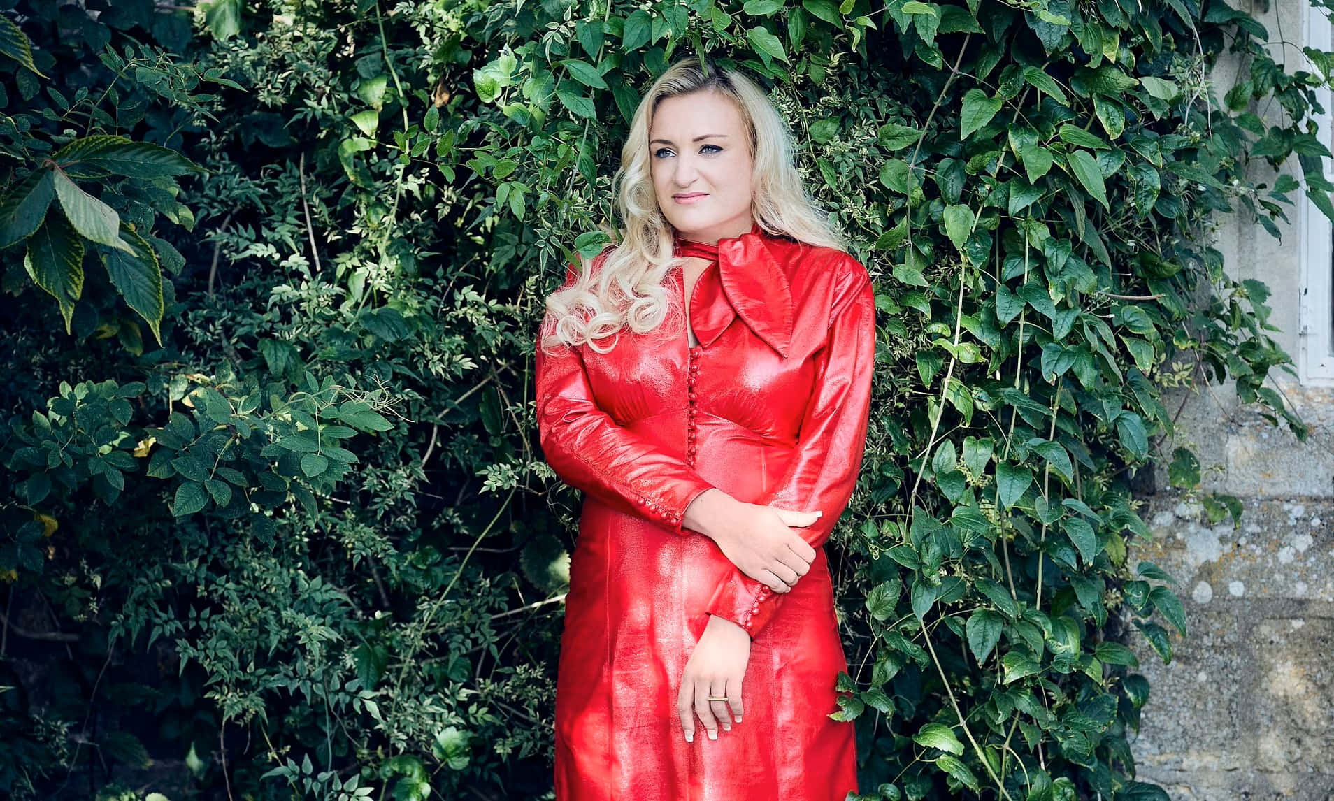 Daisy May Cooper, glossy red dress, lush green ivy-covered stone wall, HD Desktop Wallpaper