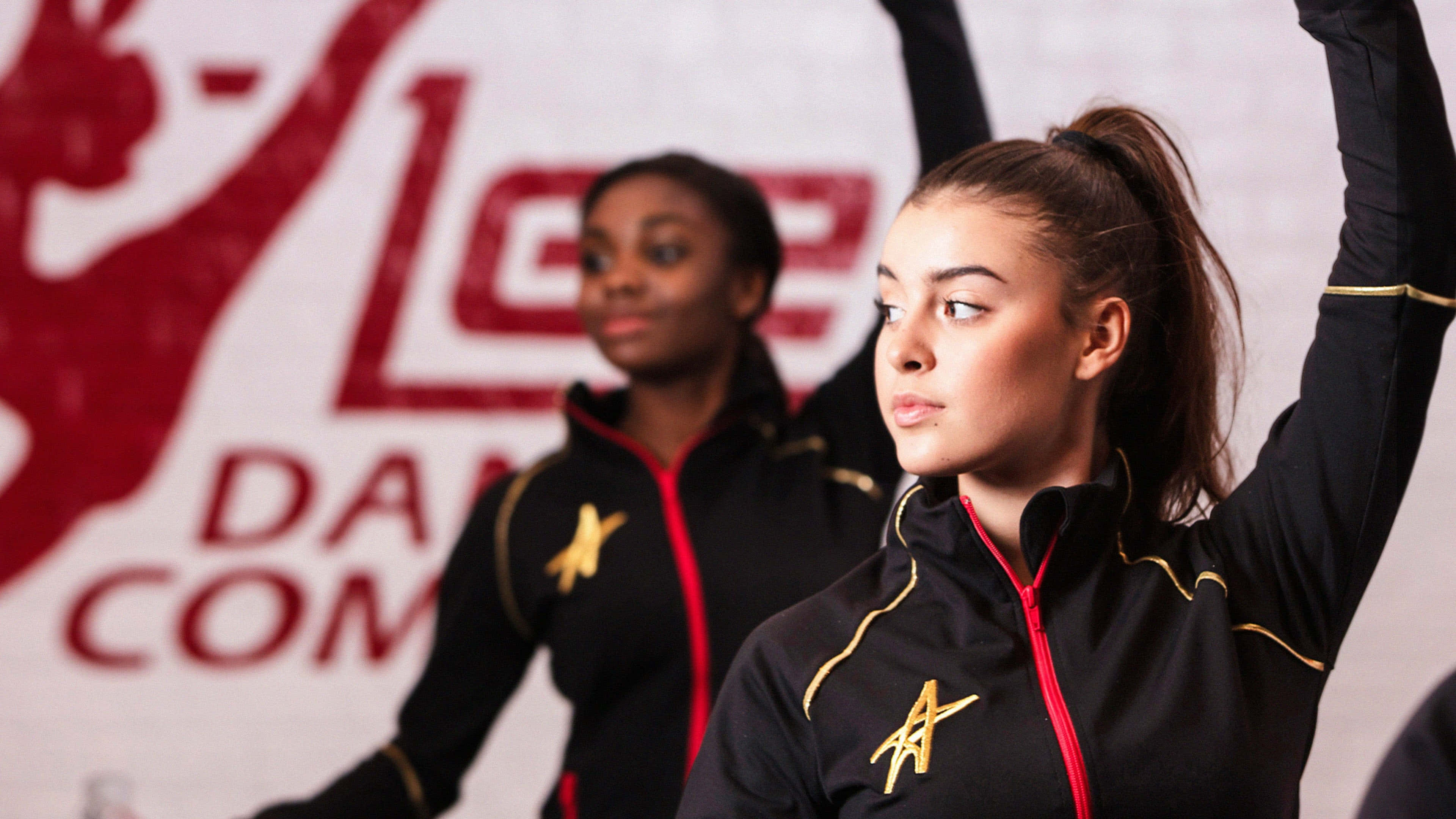 black jackets with gold accents, red and white dance competition backdrop, poised pose, 4K Desktop Wallpaper