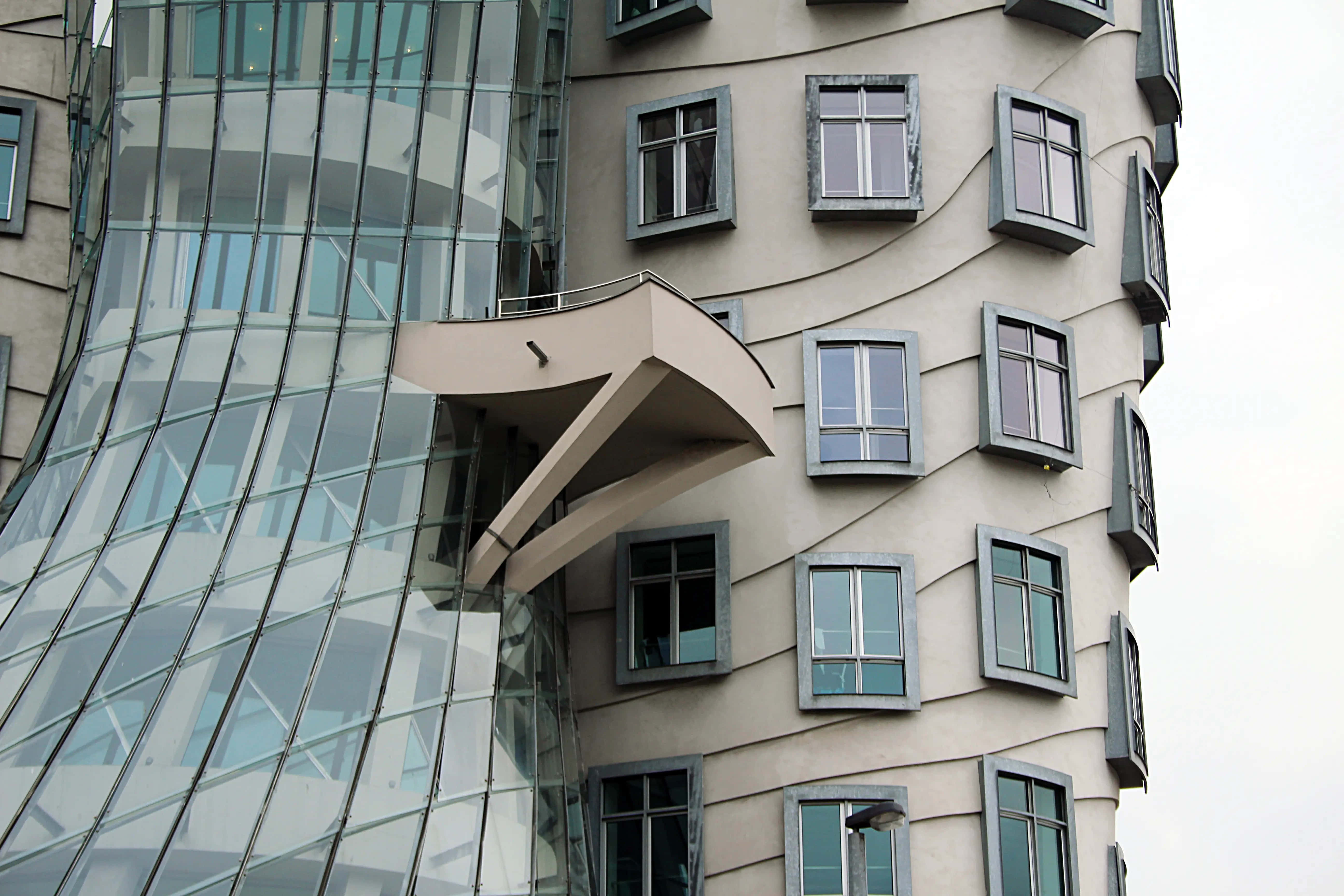 Dancing House, curved glass, beige walls, 5K Desktop Wallpaper