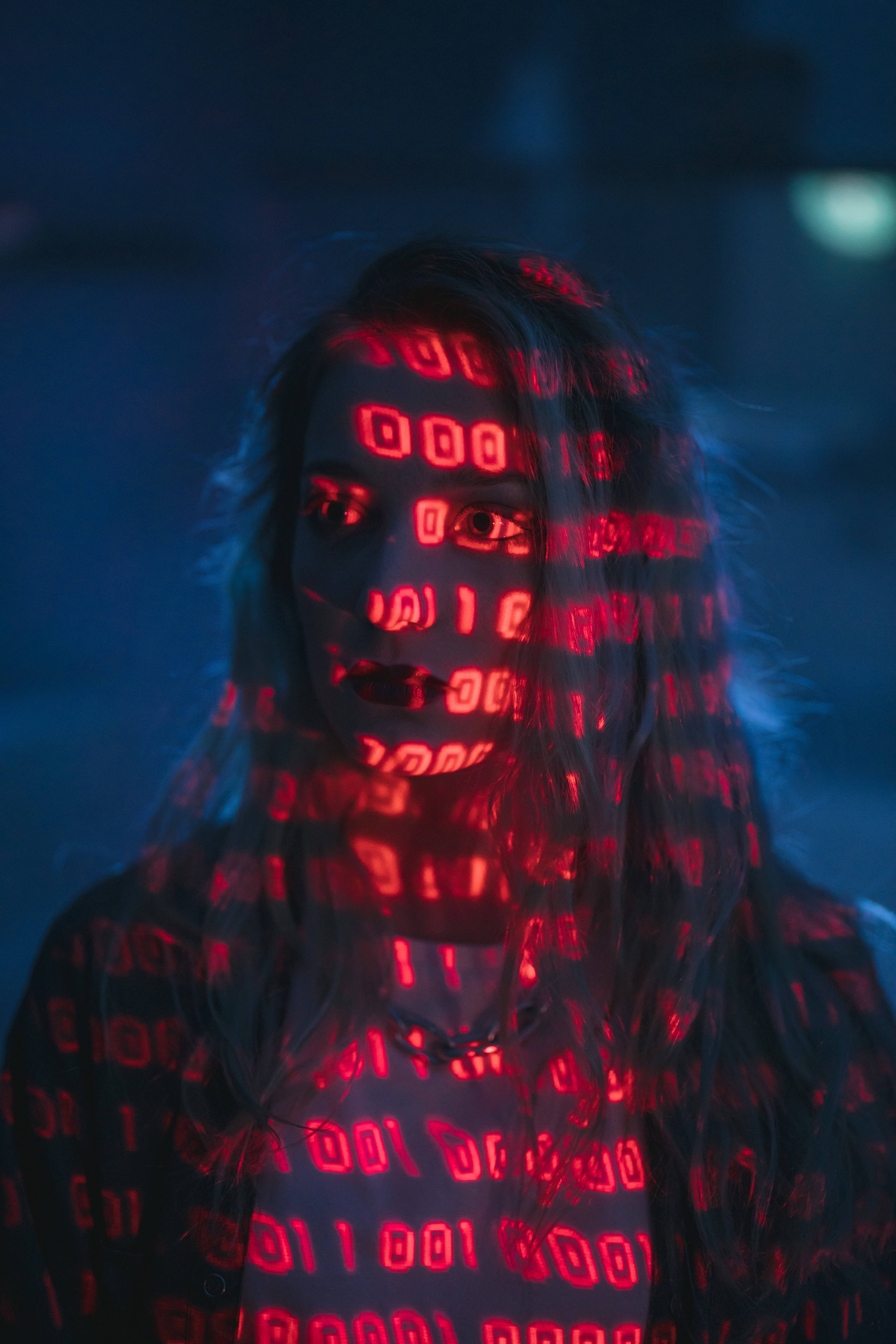 glowing red binary code, dark blue background, person's face and body, 5K Phone Wallpaper