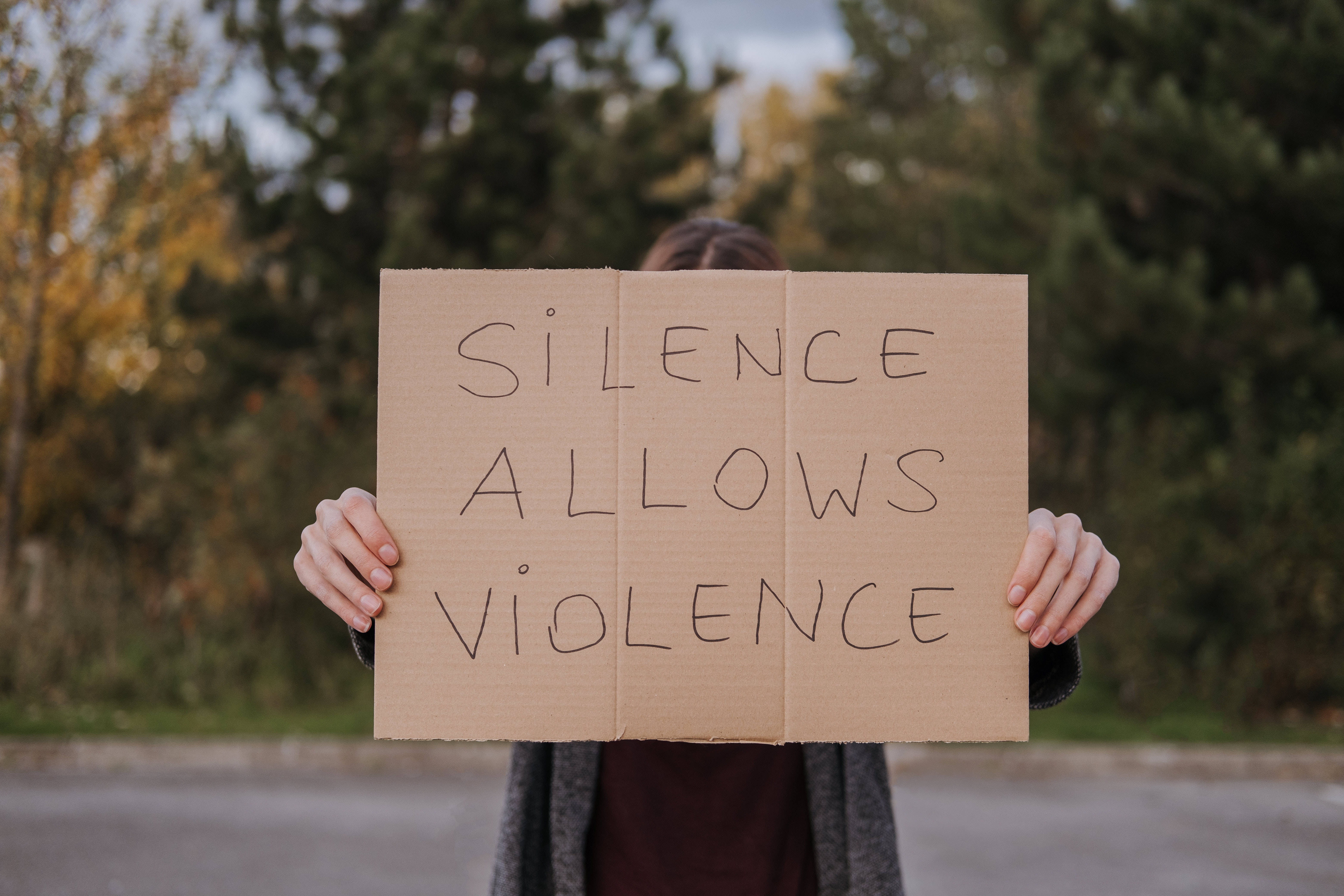 autumn forest, cardboard sign, silence allows violence, 5K Desktop Wallpaper