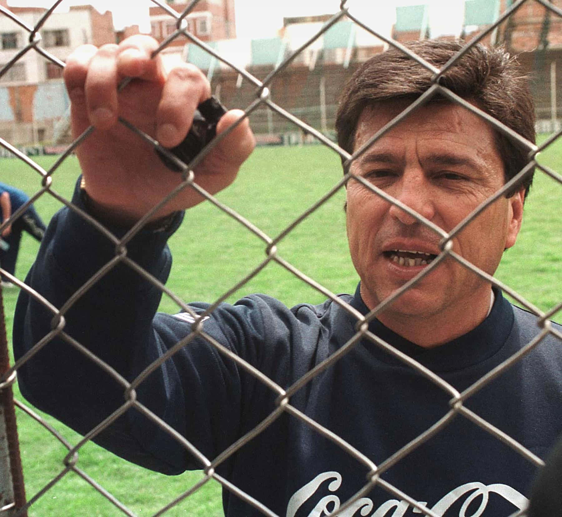 Daniel Passarella, dark blue Coca-Cola sweatshirt, chain-link fence, HD Desktop Wallpaper