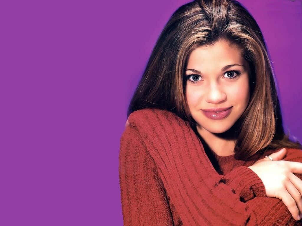 Danielle Fishel, red ribbed sweater, solid purple studio background, SD Desktop Wallpaper