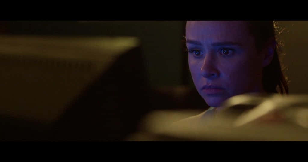 Danielle Harris, glowing screen, dimly lit room, SD Desktop Wallpaper