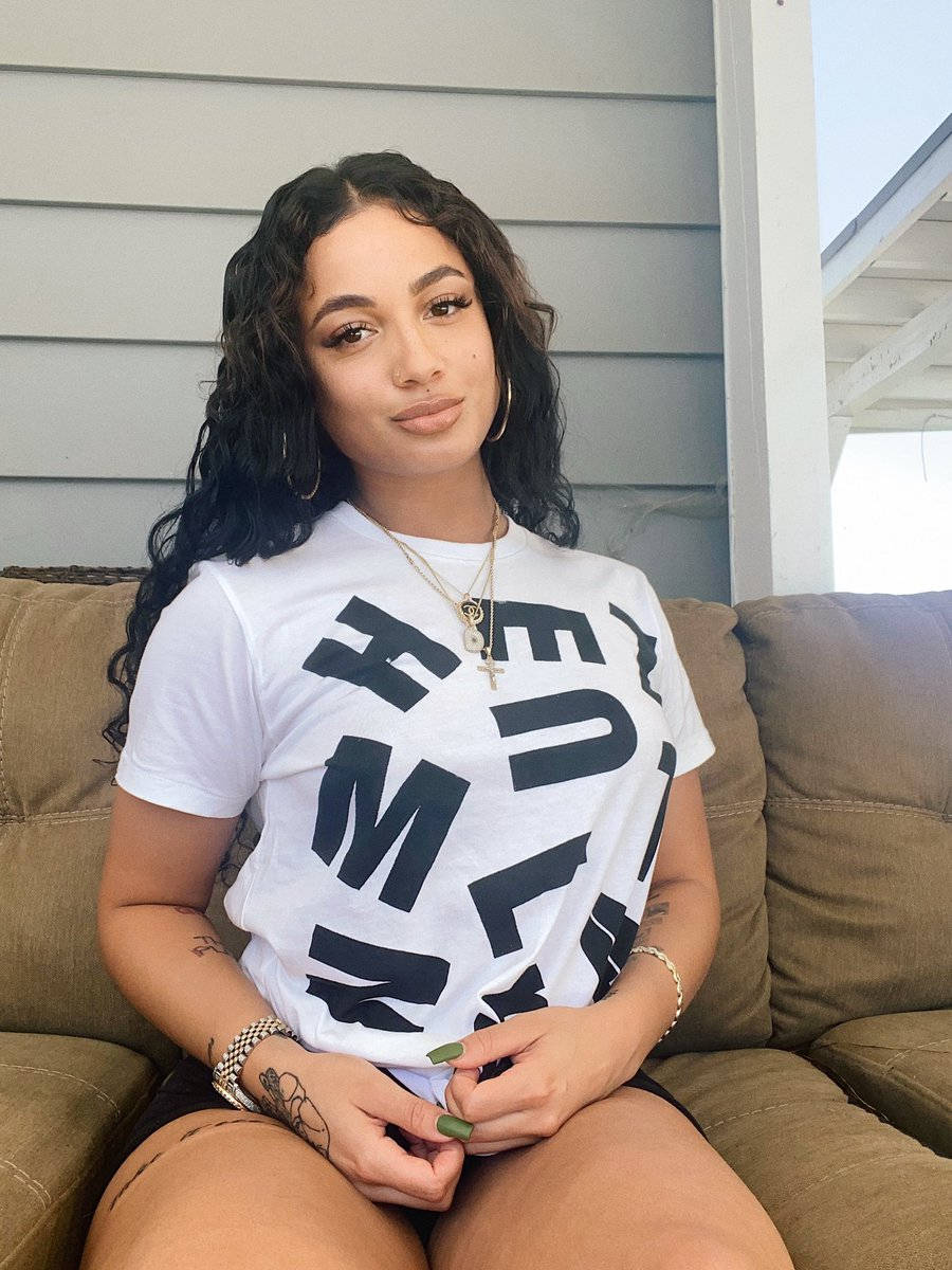 Danileigh, brown couch, white graphic tee, SD Phone Wallpaper