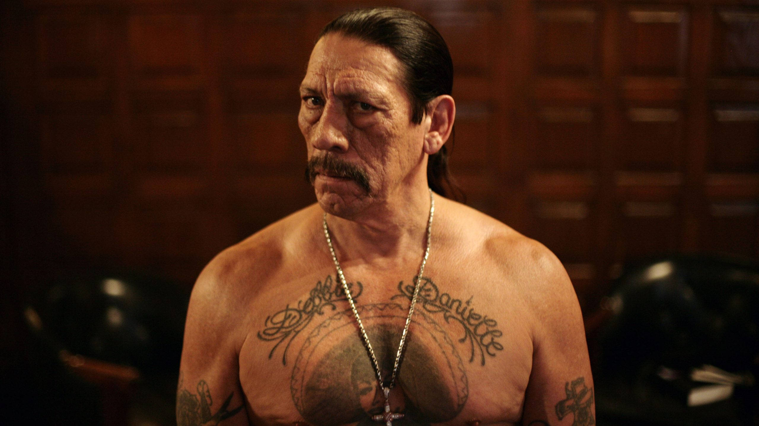 Danny Trejo, tattooed, dimly lit room, 2K Desktop Wallpaper