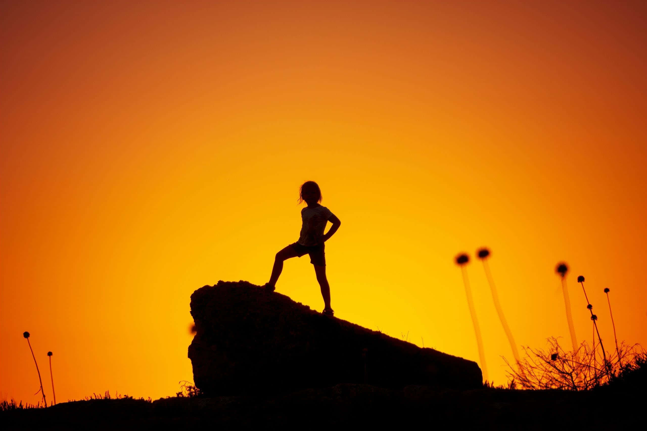 Daring, rock climber, fiery orange sunset sky, 2K Desktop Wallpaper