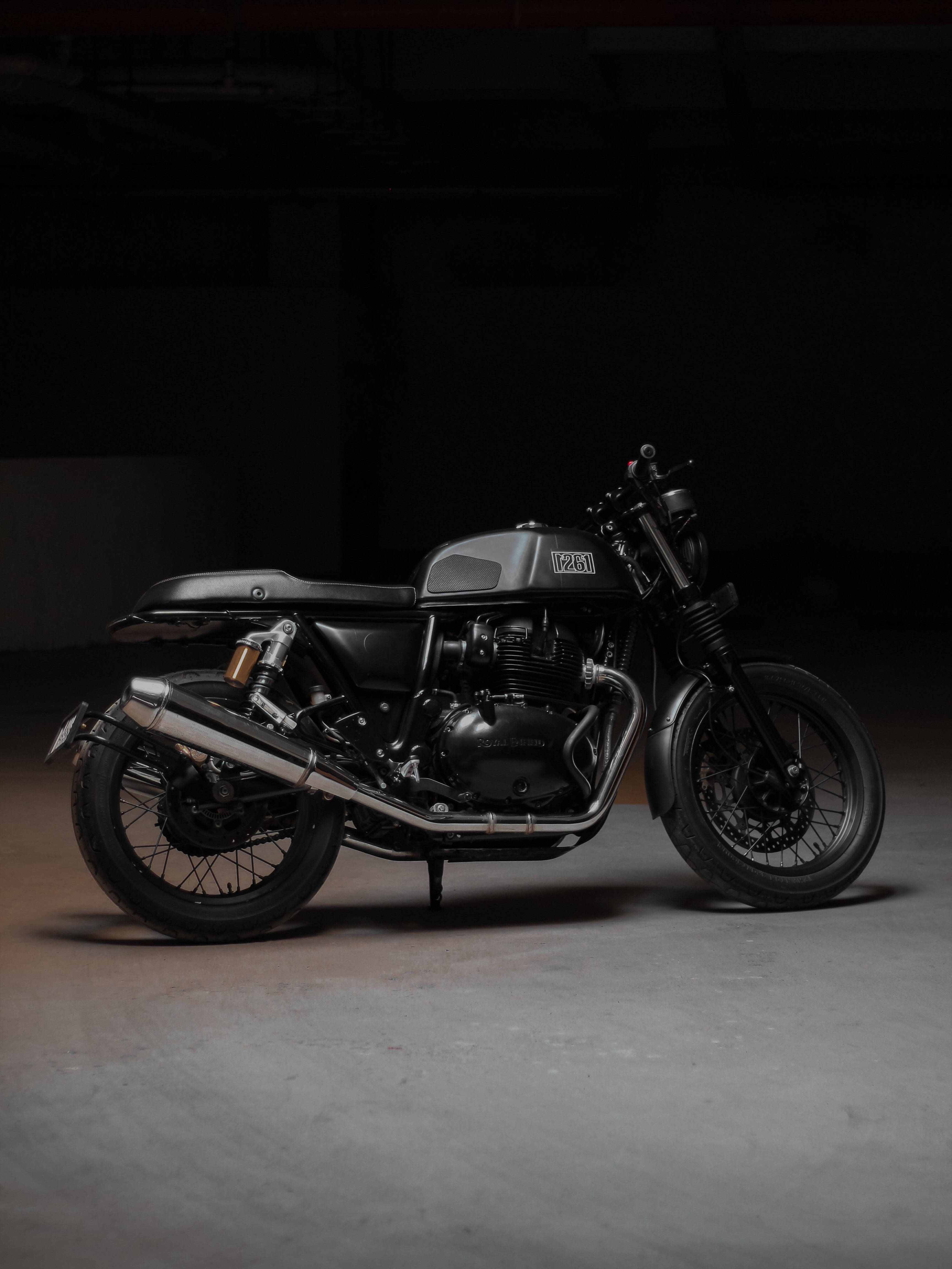 matte black motorcycle, chrome accents, dimly lit industrial garage, 4K Phone Wallpaper