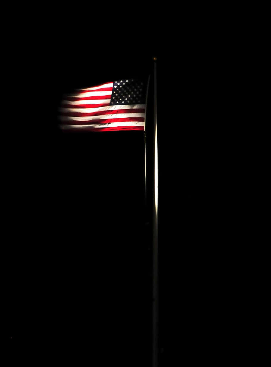 American flag, pitch black sky, light casting on the pole, SD Phone Wallpaper