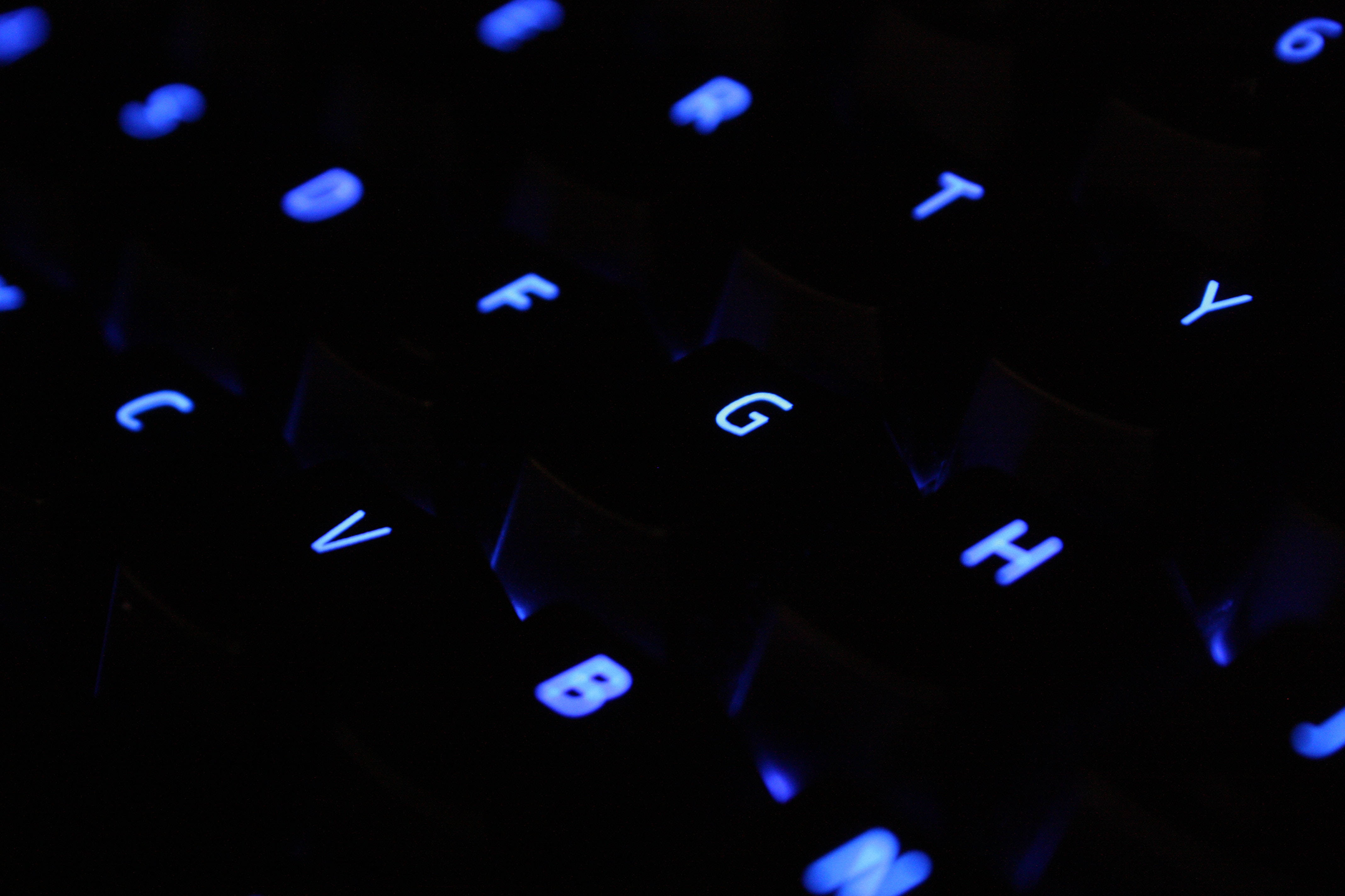 glowing blue backlit keyboard keys, deep darkness, letters G and H, 4K Desktop Wallpaper