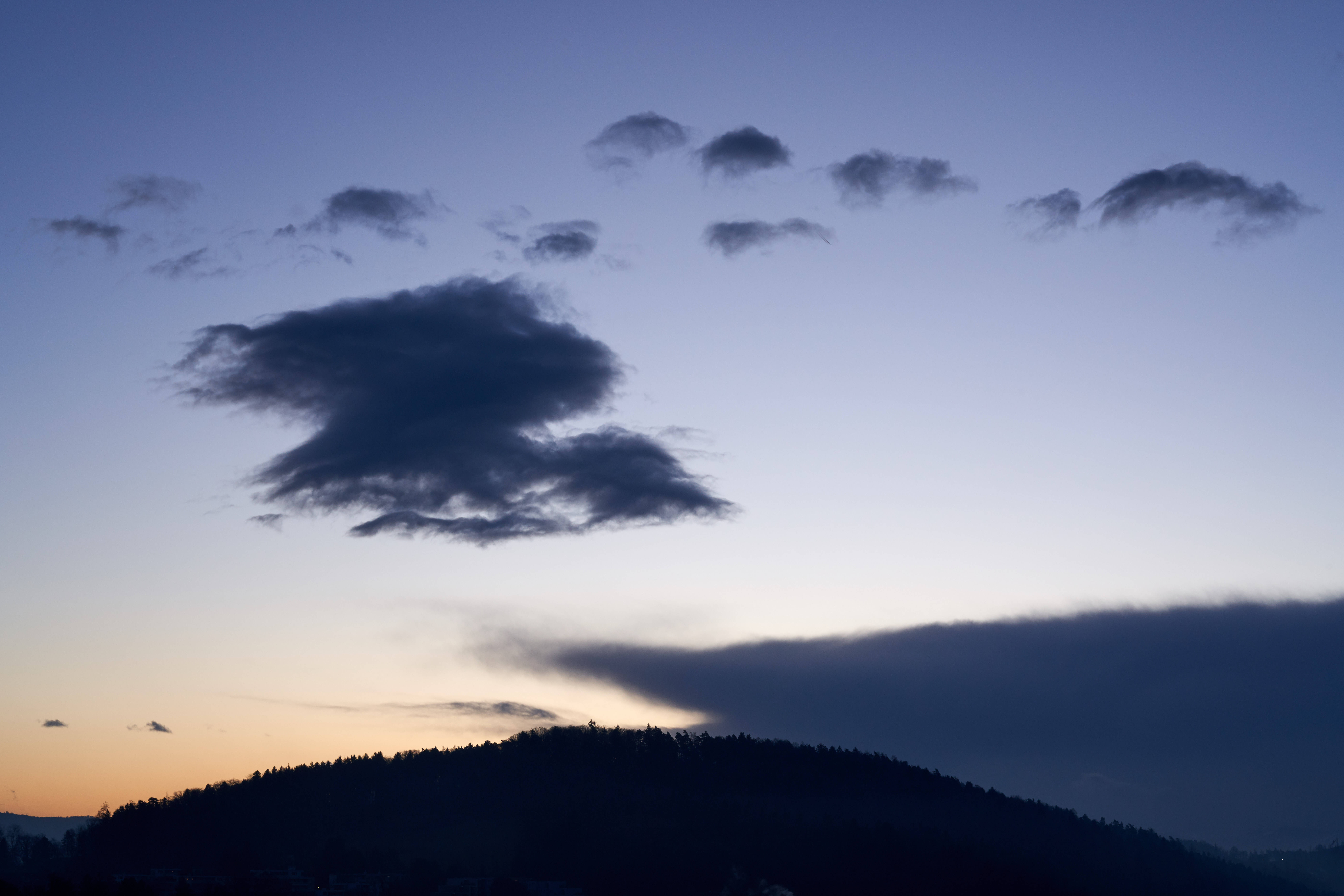 sparse dark blue clouds, twilight sky, silhouetted forested hill, 8K Desktop Wallpaper