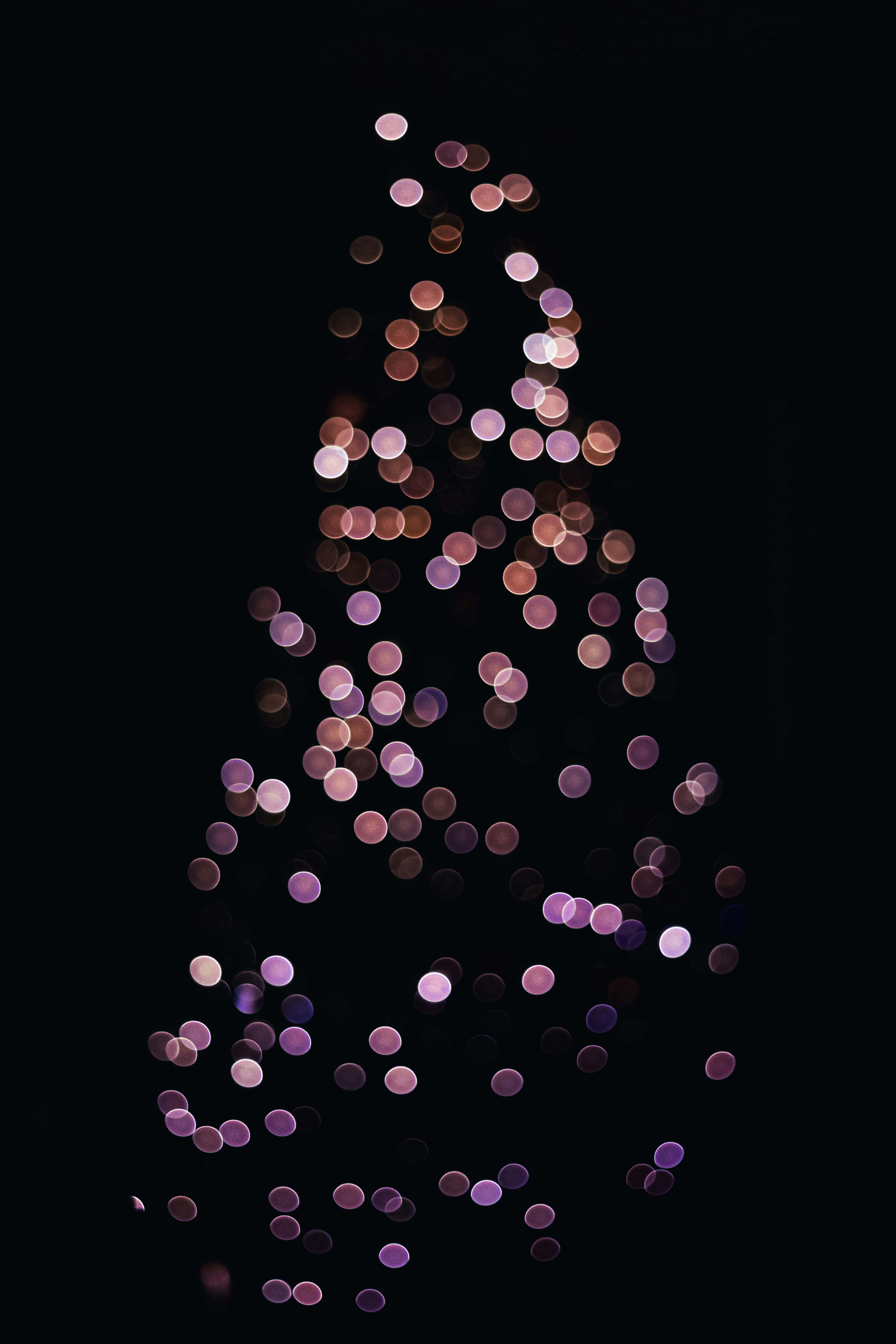 bokeh Christmas tree, glowing purple and pink lights, black background, 5K Phone Wallpaper