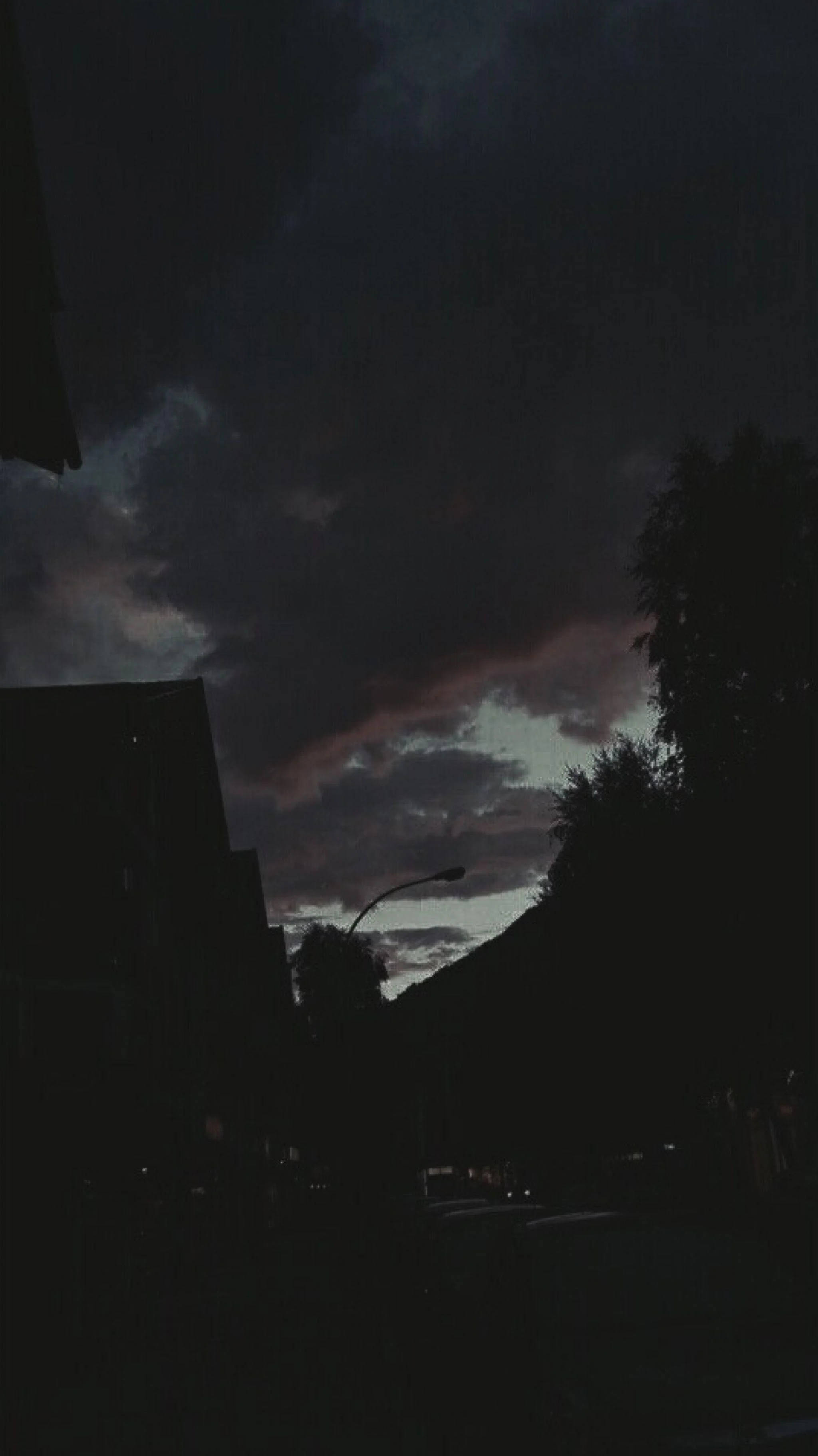 dim sky, bruised purple and gray clouds, city buildings, 2K Phone Wallpaper