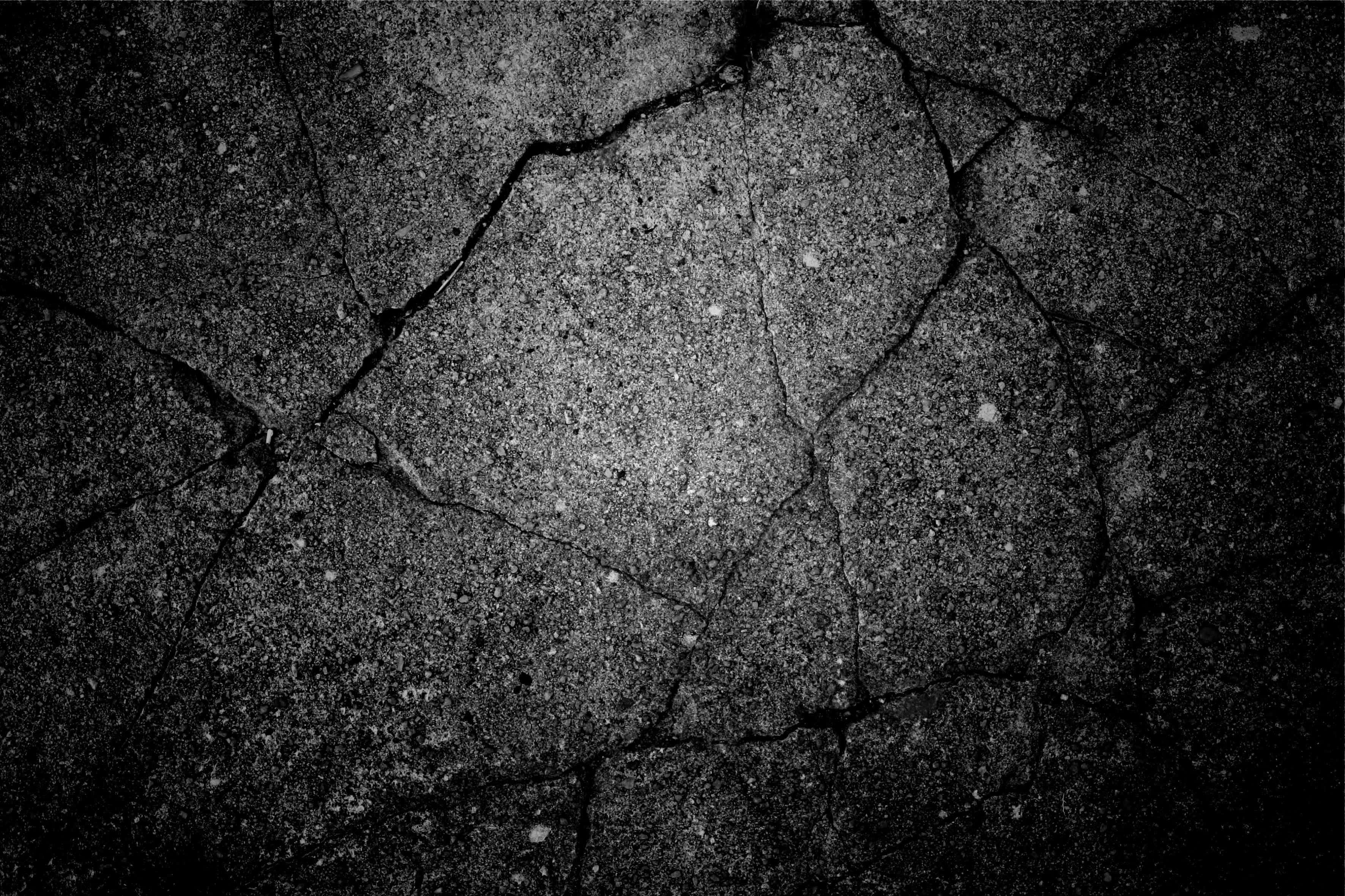 cracked asphalt, deep fissures, scattered specks, 2K Desktop Wallpaper
