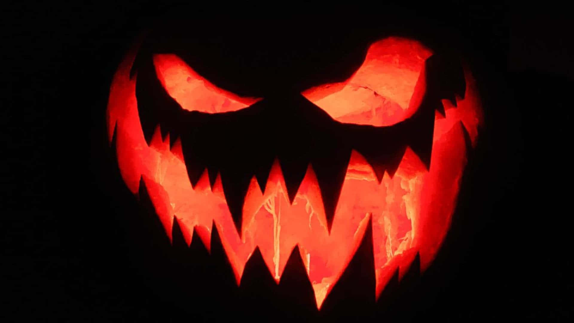 glowing jack o lantern face, glowing red eyes, jagged teeth, Full HD Desktop Wallpaper