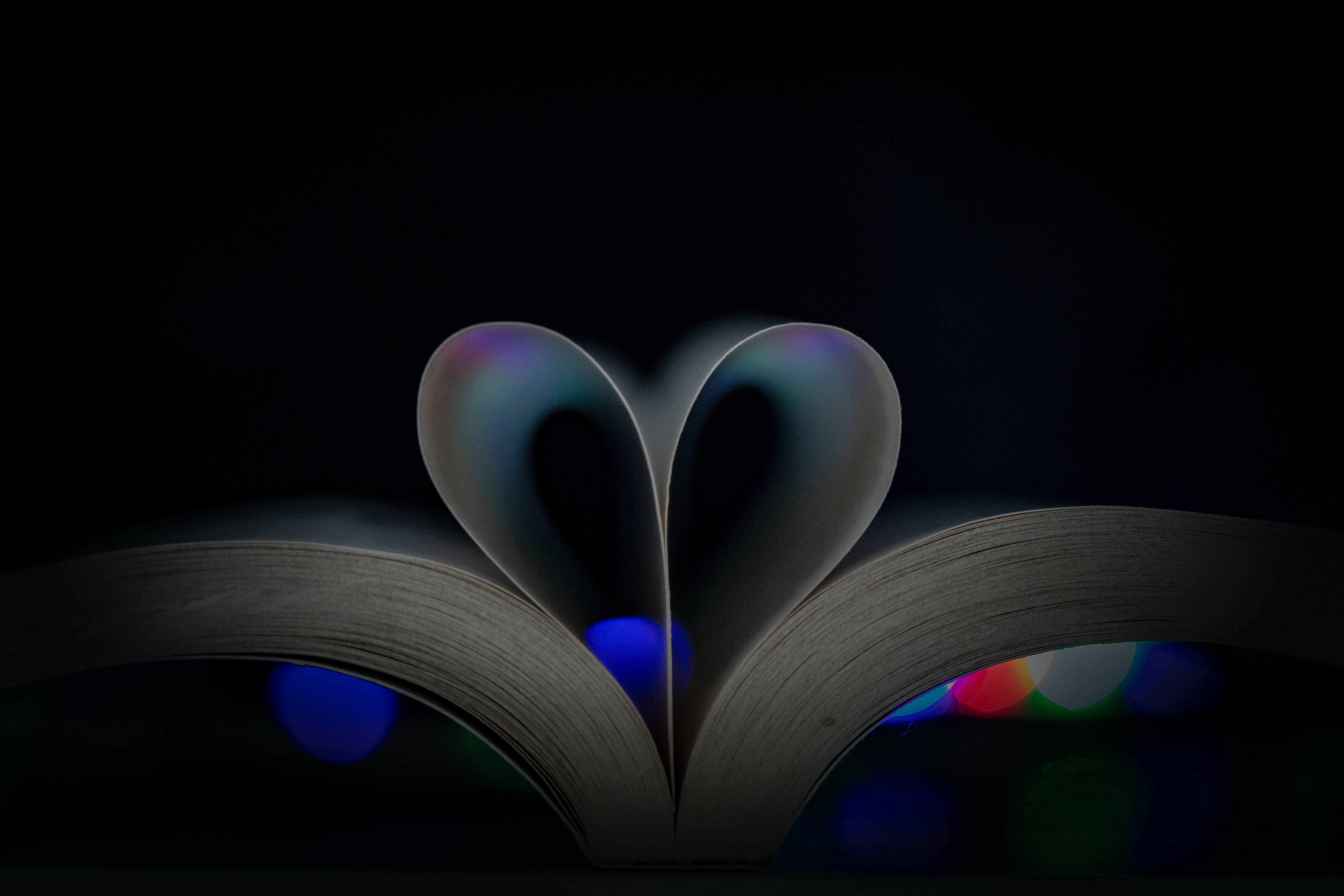 folded book pages, heart shape, dark background, 5K Desktop Wallpaper