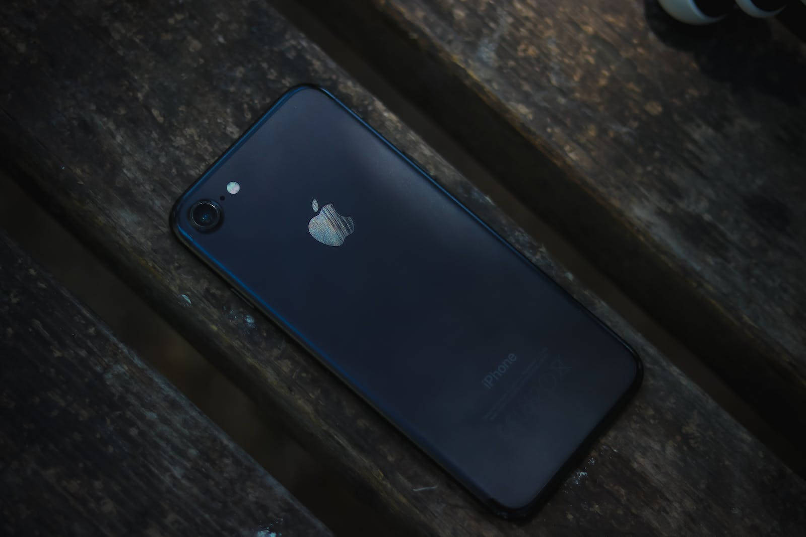 dark blue iPhone 7, weathered wooden planks, dim lighting, HD Desktop Wallpaper