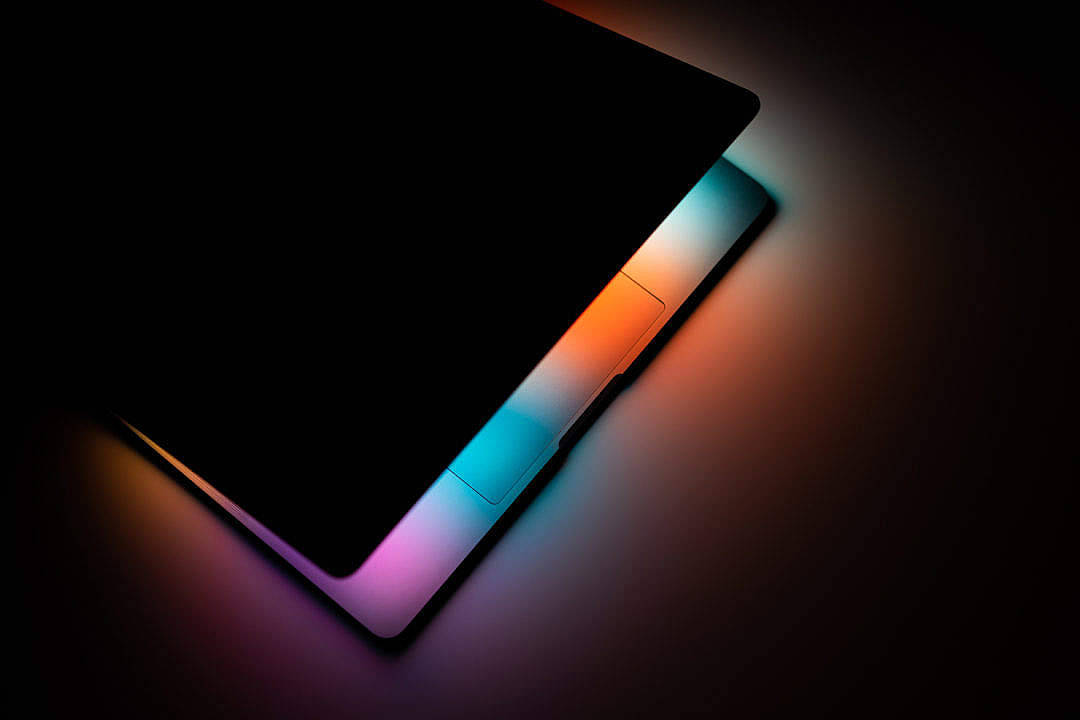 black color laptop, half open screen, vibrant rainbow backlighting, SD Desktop Wallpaper