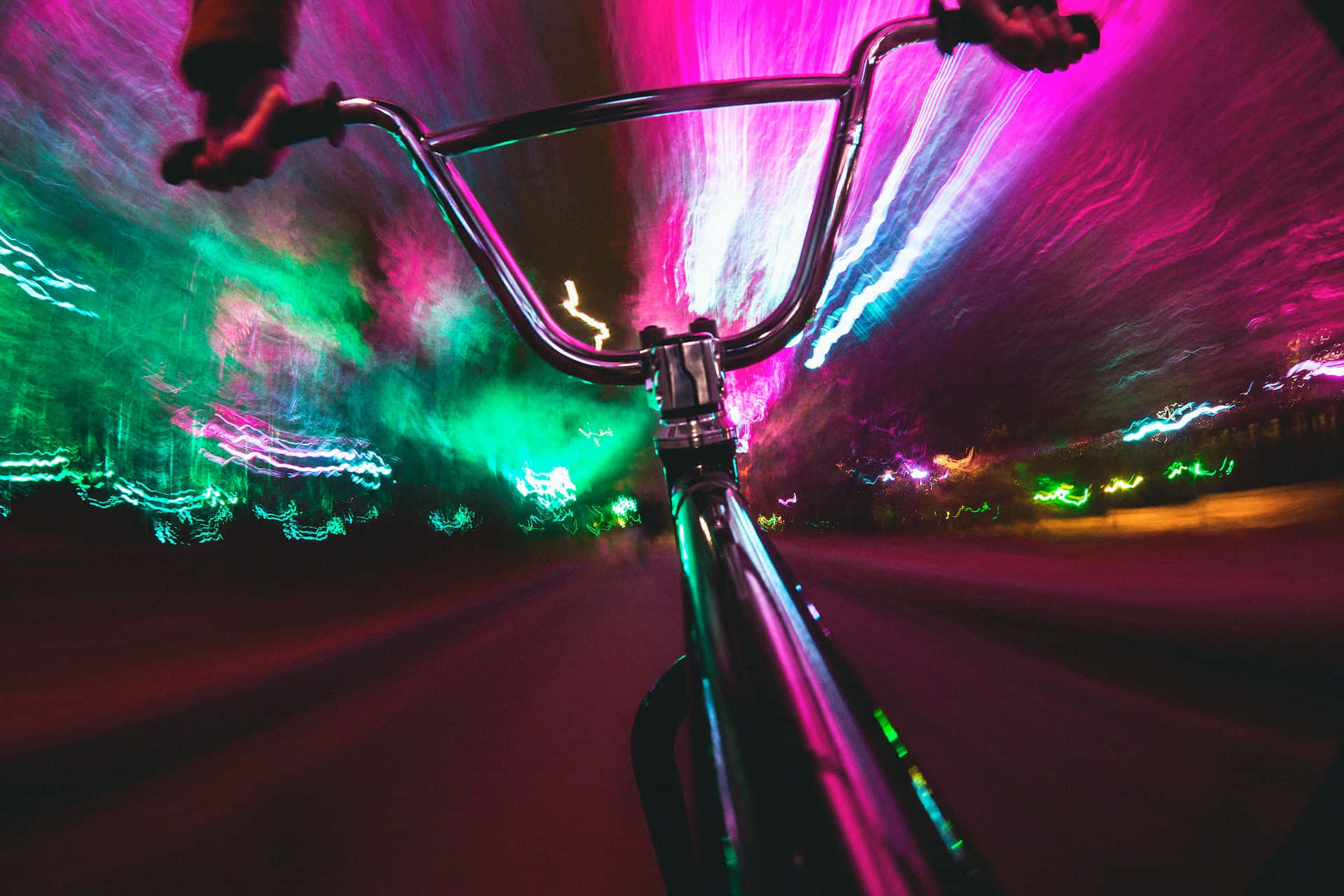 neon-drenched urban night, streaking pink green and blue lights, bike, Full HD Desktop Wallpaper