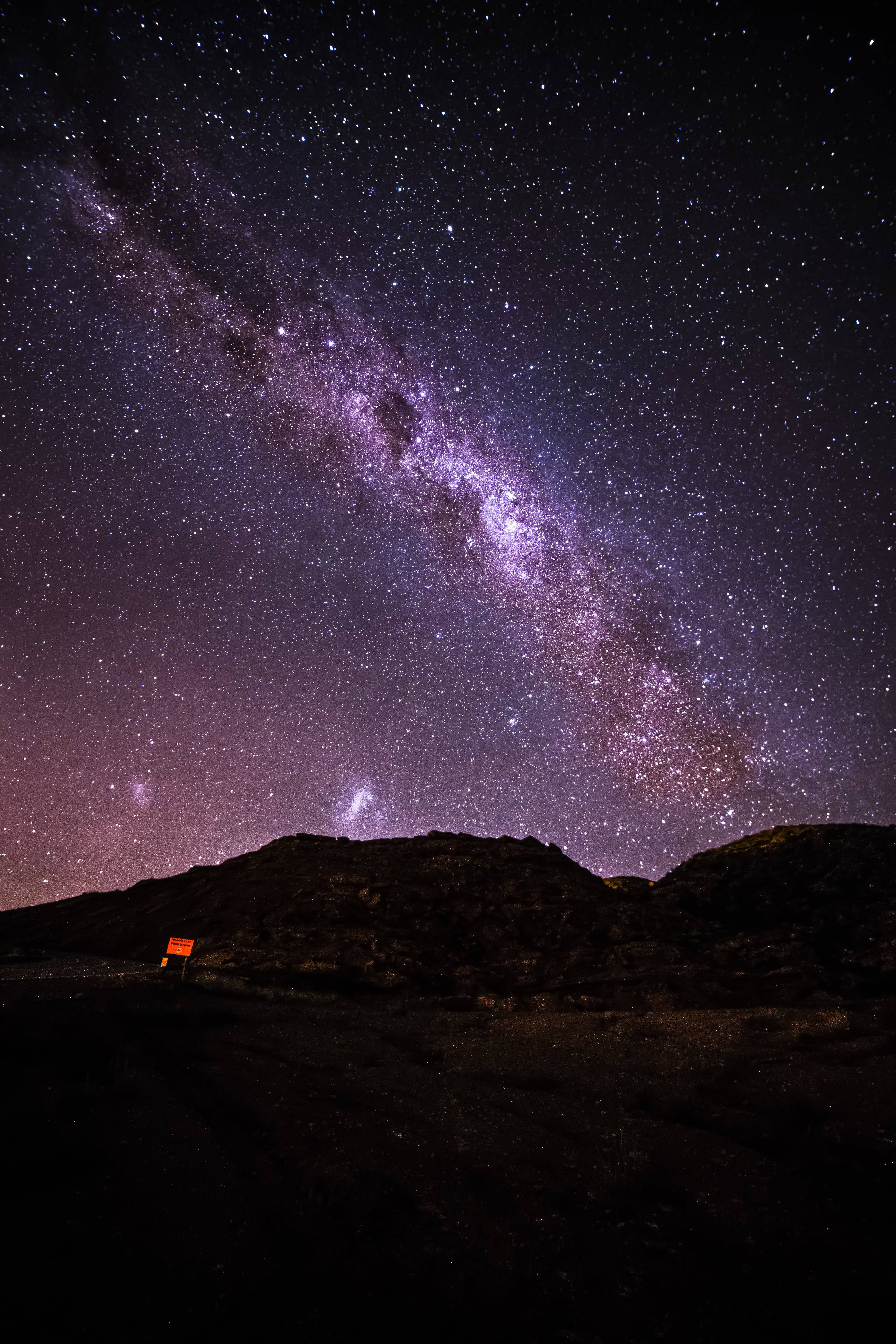 Purple Galaxy, vibrant purple Milky Way, dark rugged hills, 5K Phone Wallpaper